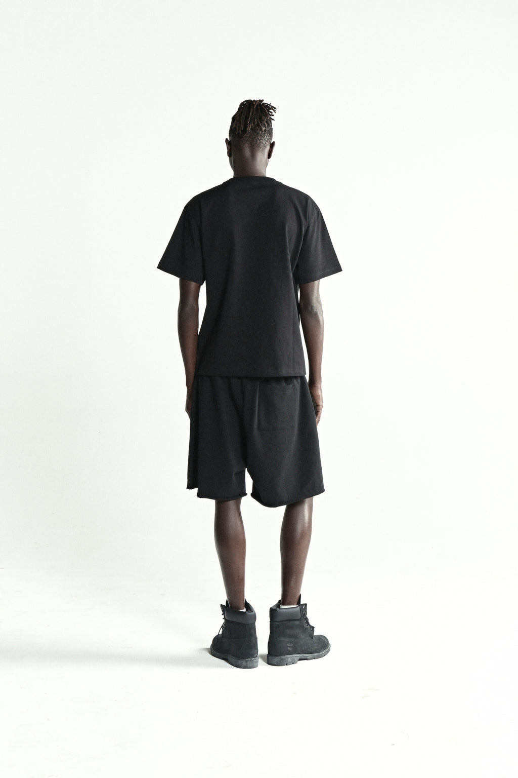 Black 100% cotton tee with rhinestone 5-star design, worn by a model from behind.