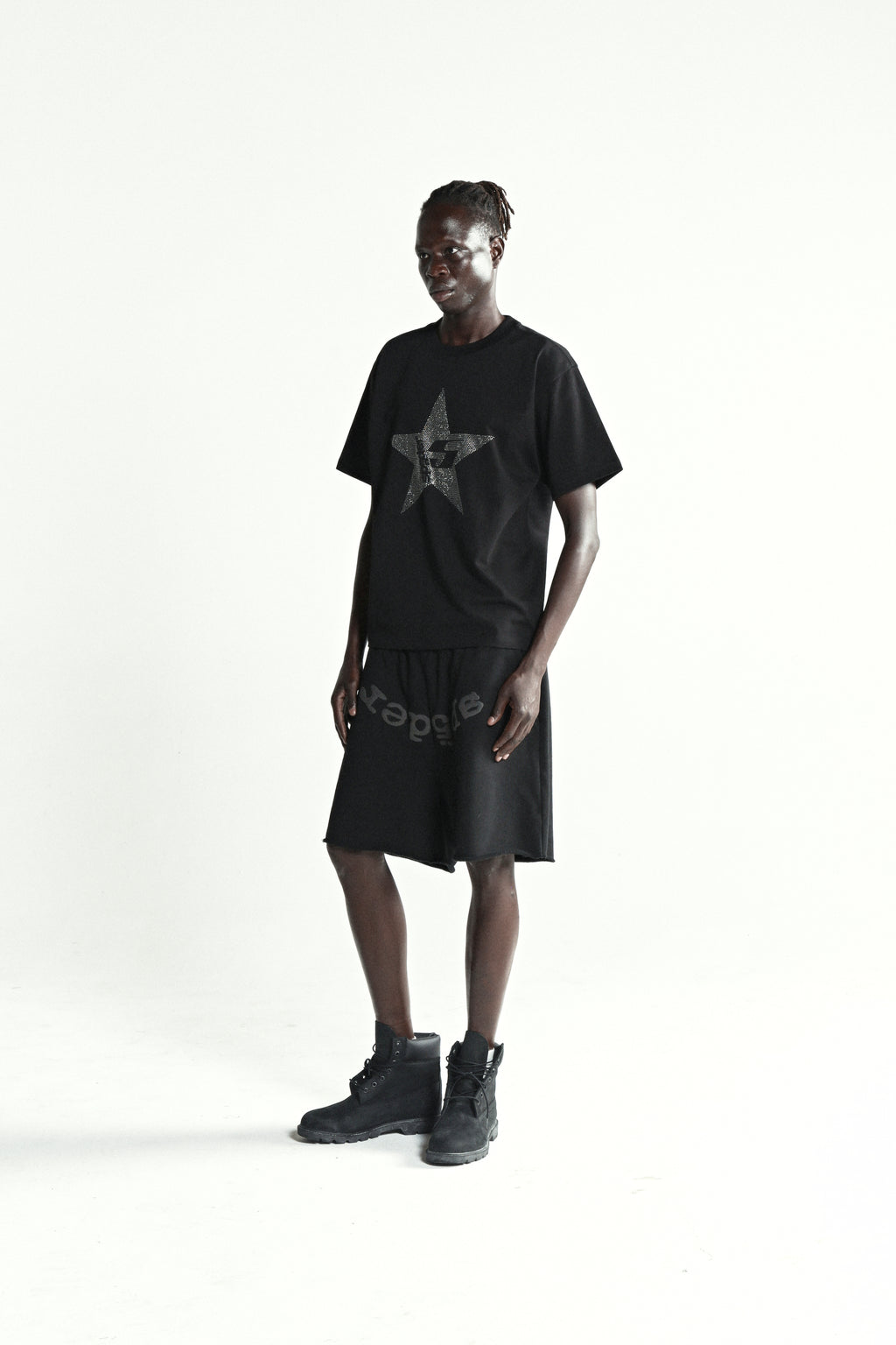 Black 100% cotton tee with rhinestone embellished 5-star design, worn by a model.