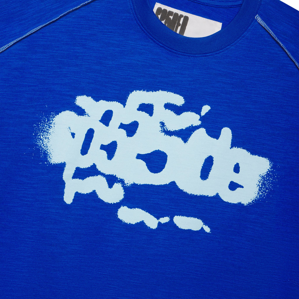 Blue slub tee with light blue graphic print and white contrast stitching.