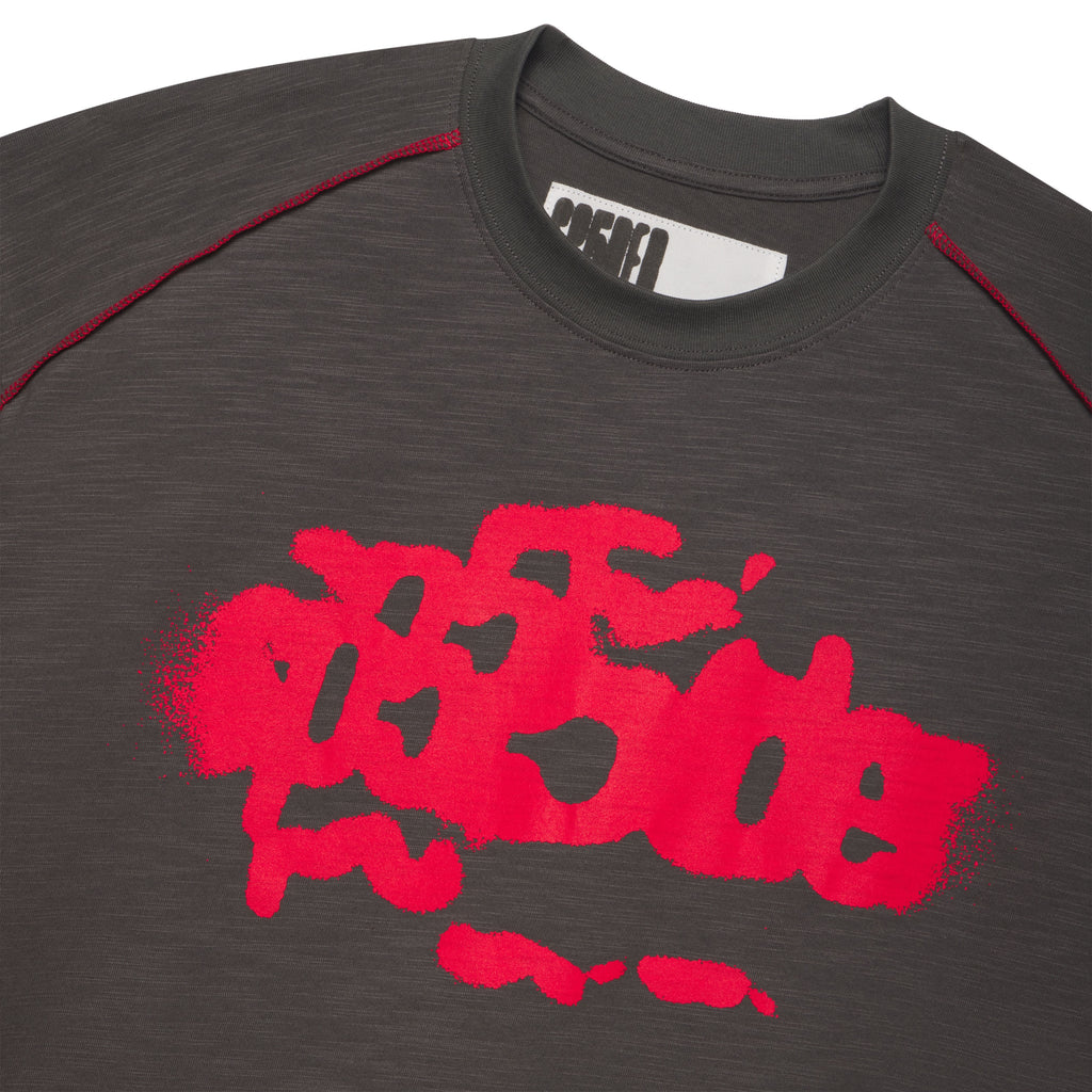 Dark gray slub tee with red contrast stitching and a bold red graphic print.