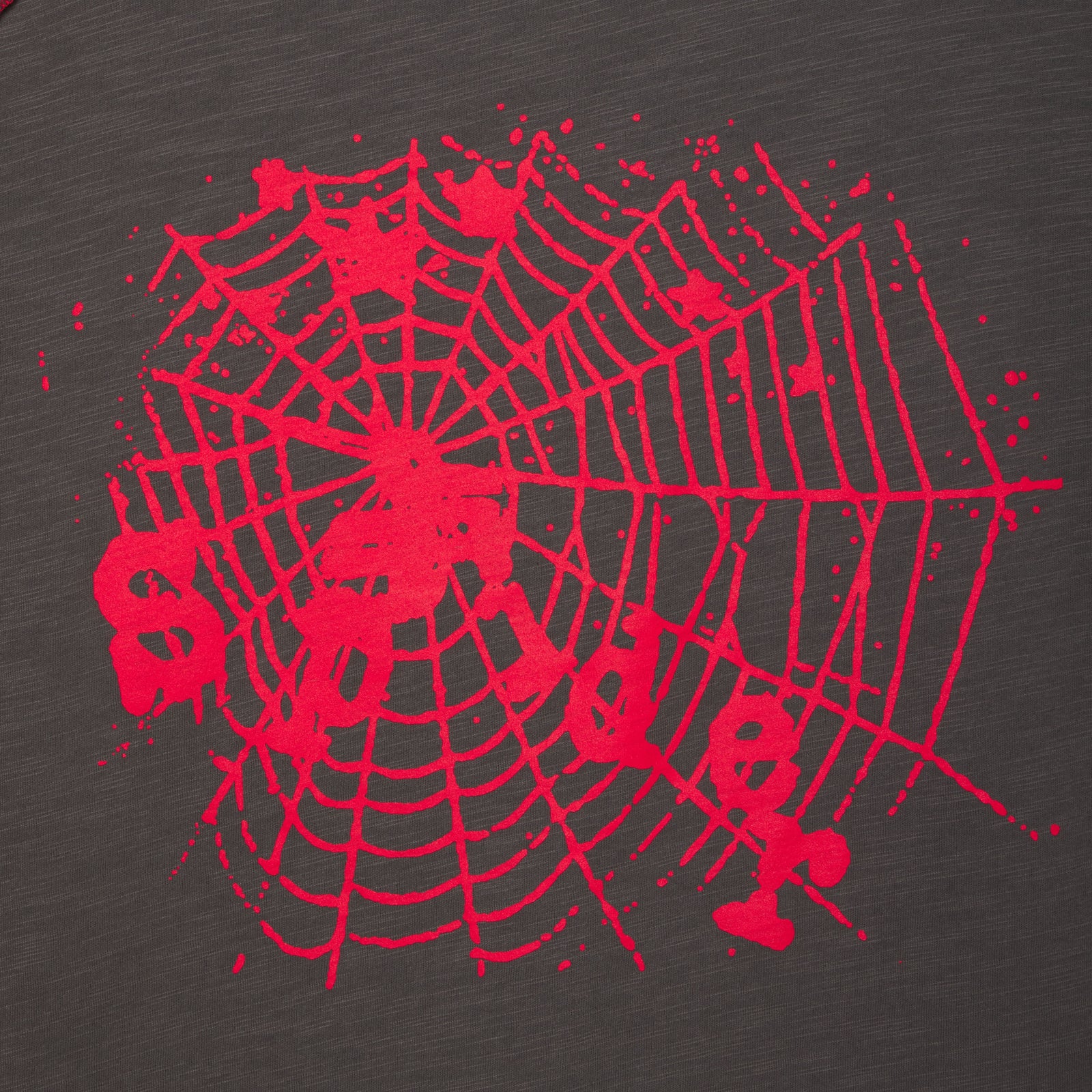Close-up of a dark gray slub tee with a vibrant red spiderweb graphic print.
