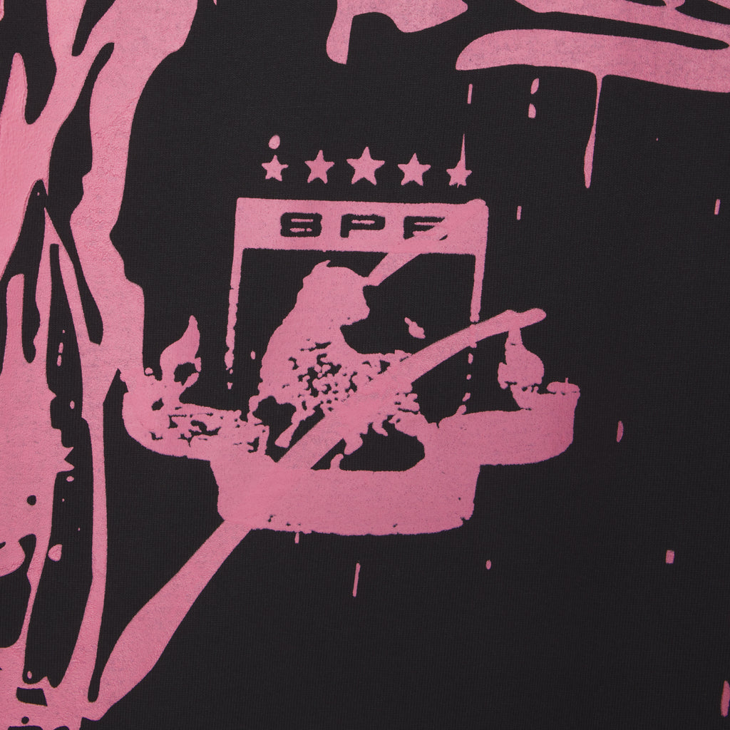 Black 100% cotton tee with pink trompe l'œil graphic print featuring "SPF" and stars.