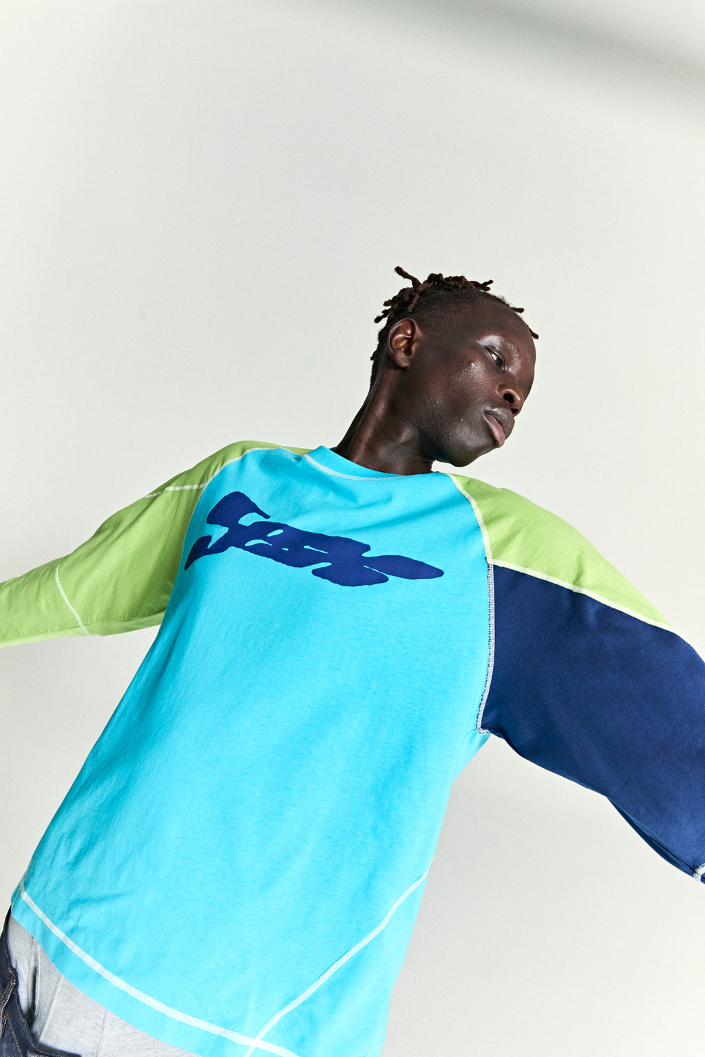 Technomarine long sleeve cotton shirt with blue, lime green, and navy color block, raglan sleeves, and chest print.