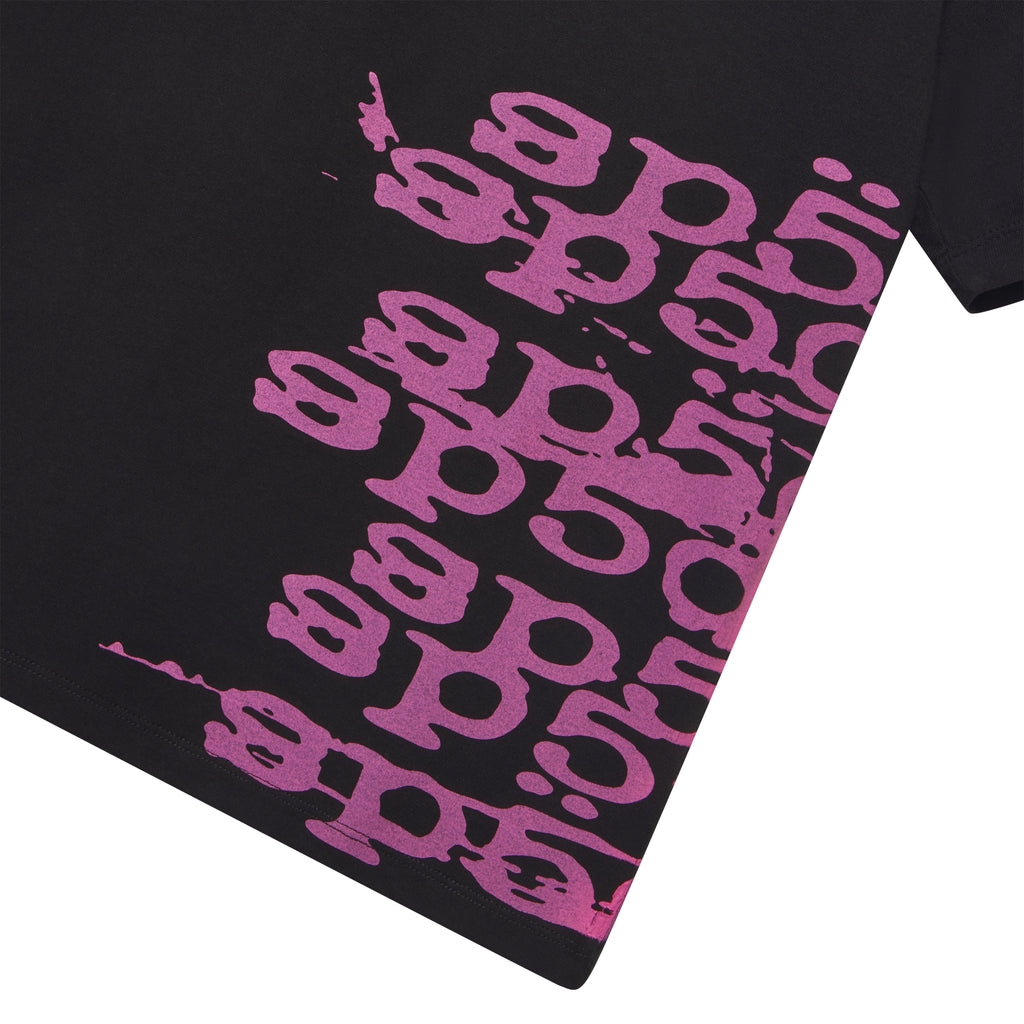 Black 100% cotton STACKED TEE with a vibrant pink wraparound graphic print.