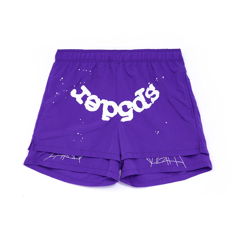 Purple nylon shorts with white "sp5der" text, web print, and stars, featuring a high-low double-layer design.