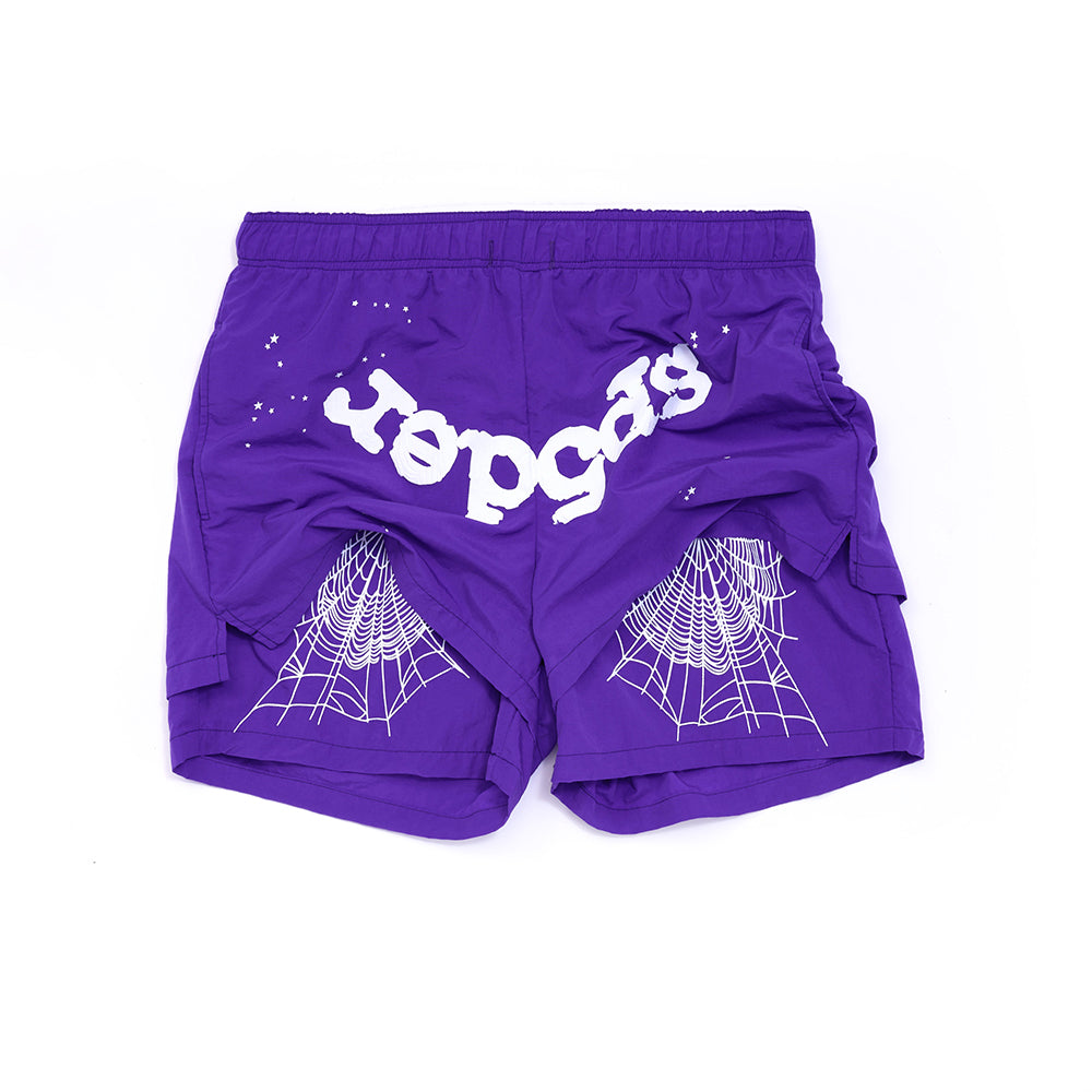 Purple nylon shorts with white "Sp5der" text and spider web graphics.