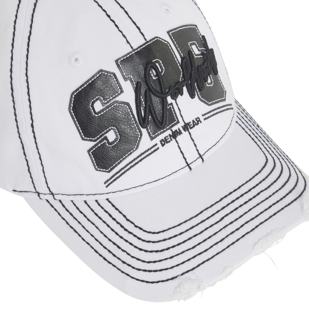 White denim baseball cap with black contrast stitching, layered SP5 logo appliqué, script embroidery, and a distressed curved brim.