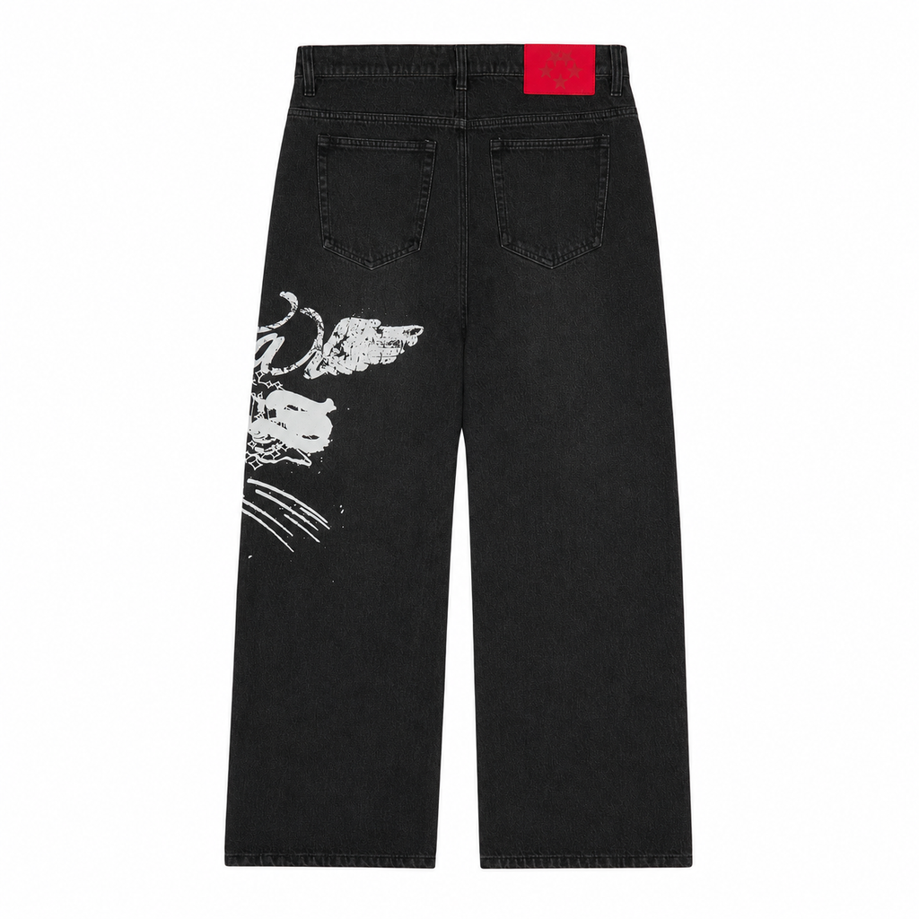 Black straight-leg denim jeans featuring a white graphic print on the leg and a red branded leather back patch.