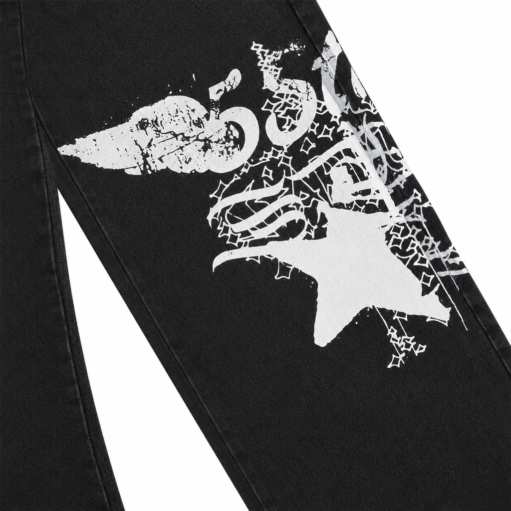 Black denim pants featuring a large, distressed white graphic print on the leg in a straight-leg fit.