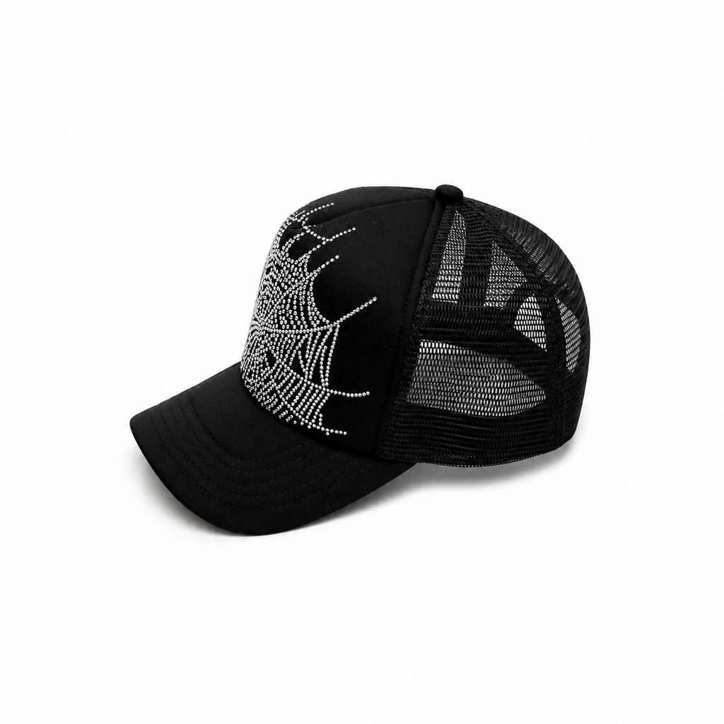 Black trucker hat with a silver rhinestone spider web graphic print, curved brim, and adjustable snapback closure.