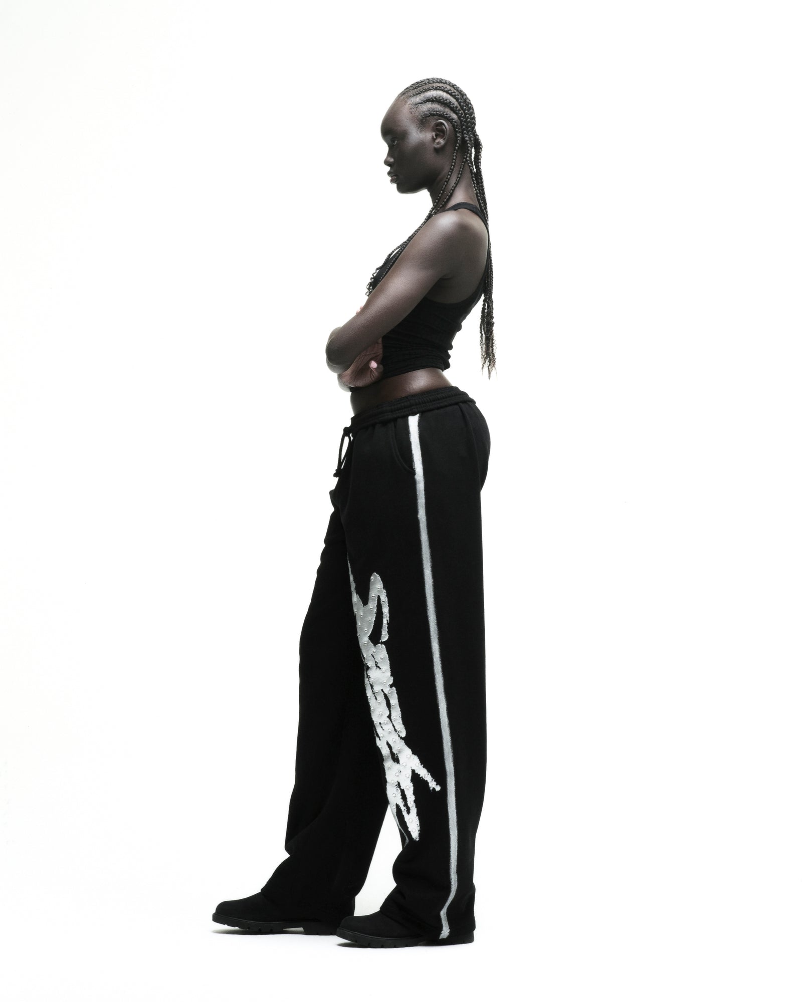 Black cotton fleece wide-leg sweatpants with rhinestone "SP5DER" logo and sprayed side stripe.