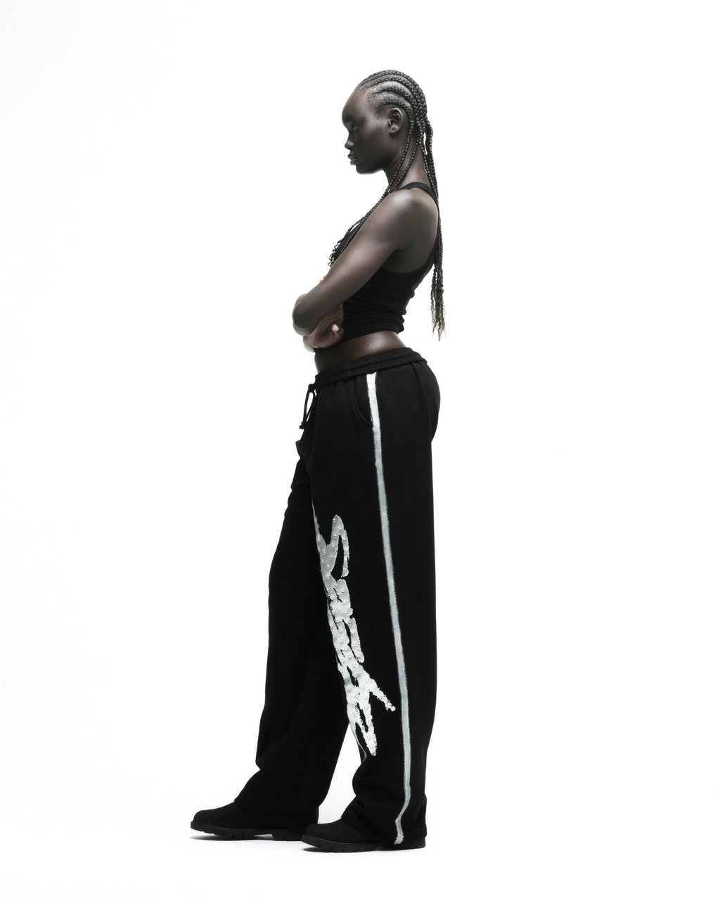 Black cotton fleece wide-leg sweatpants with rhinestone "SP5DER" logo and sprayed side stripe.