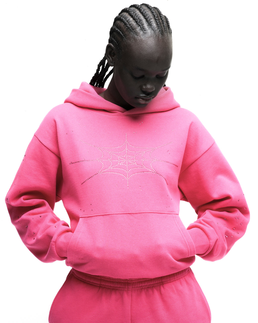 Pink cotton fleece hoodie with rhinestone spiderweb design and kangaroo pocket.