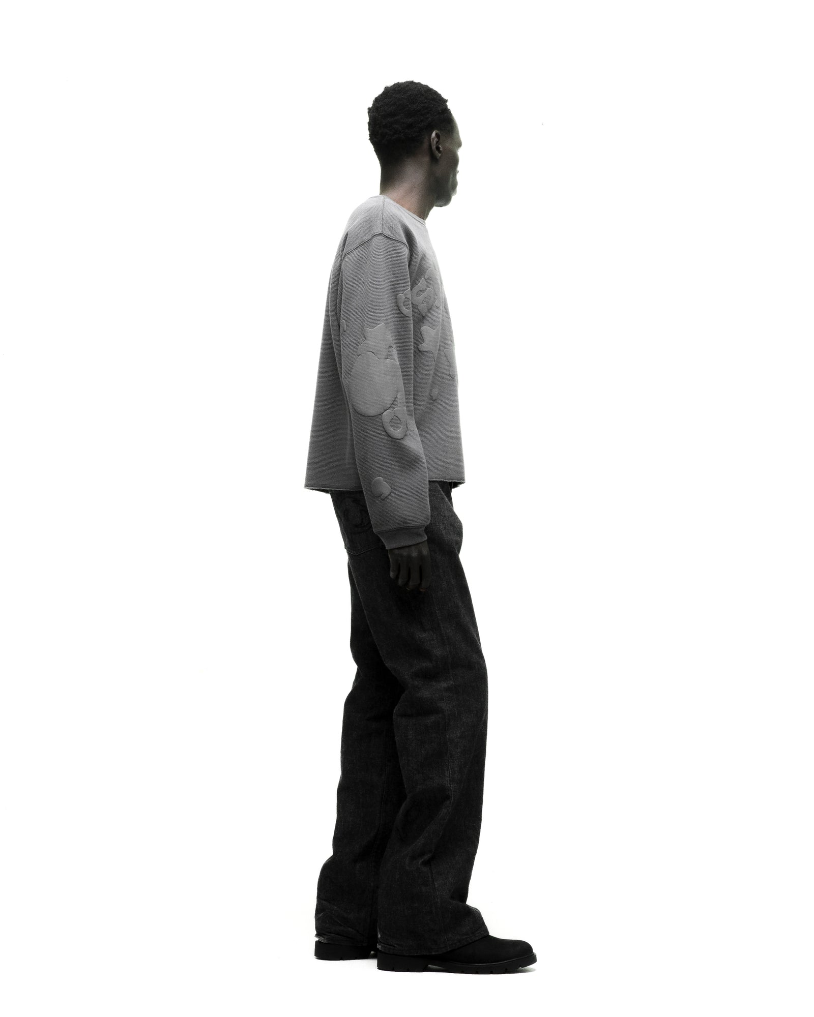 Man in a grey waffle knit thermal with Beluga print, ribbed collar, hem, and cuffs, paired with dark jeans.