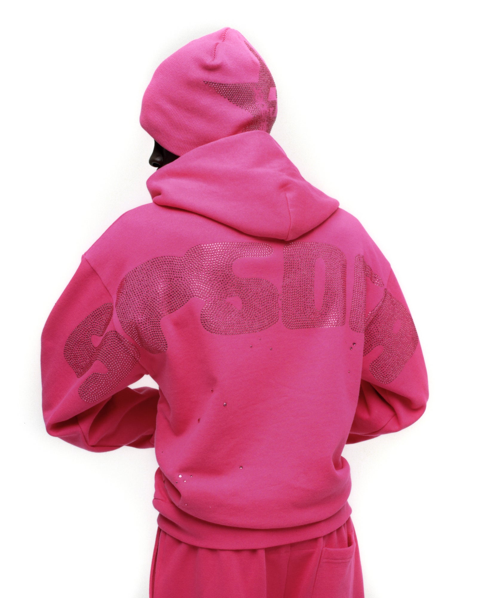 Pink cotton fleece hoodie with rhinestone design on back, matching beanie.