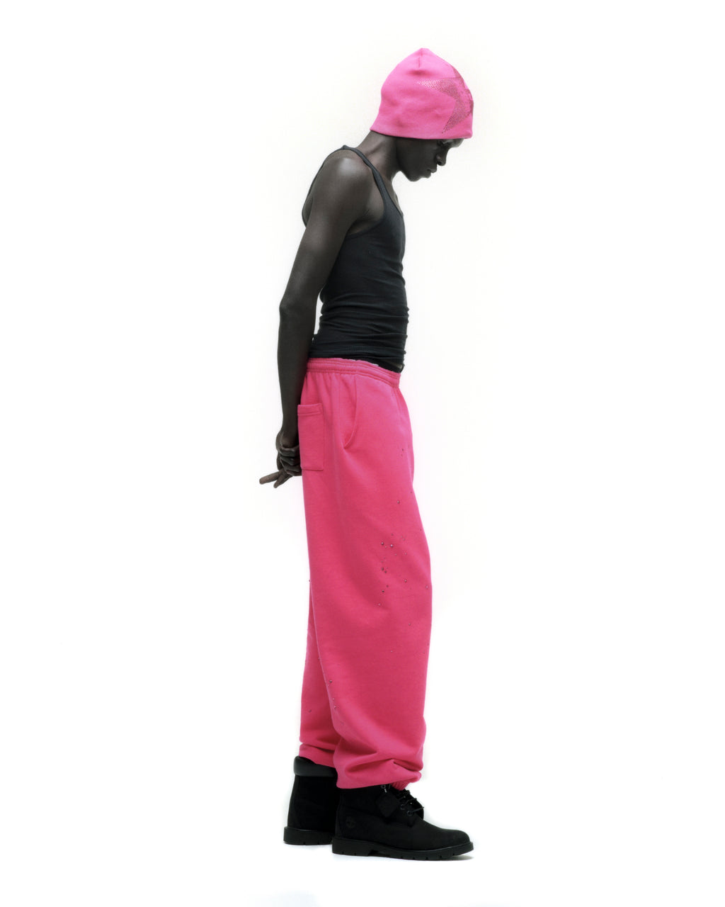 Model wearing hot pink rhinestone silk sweatpants with elasticized cuffs and waistband.