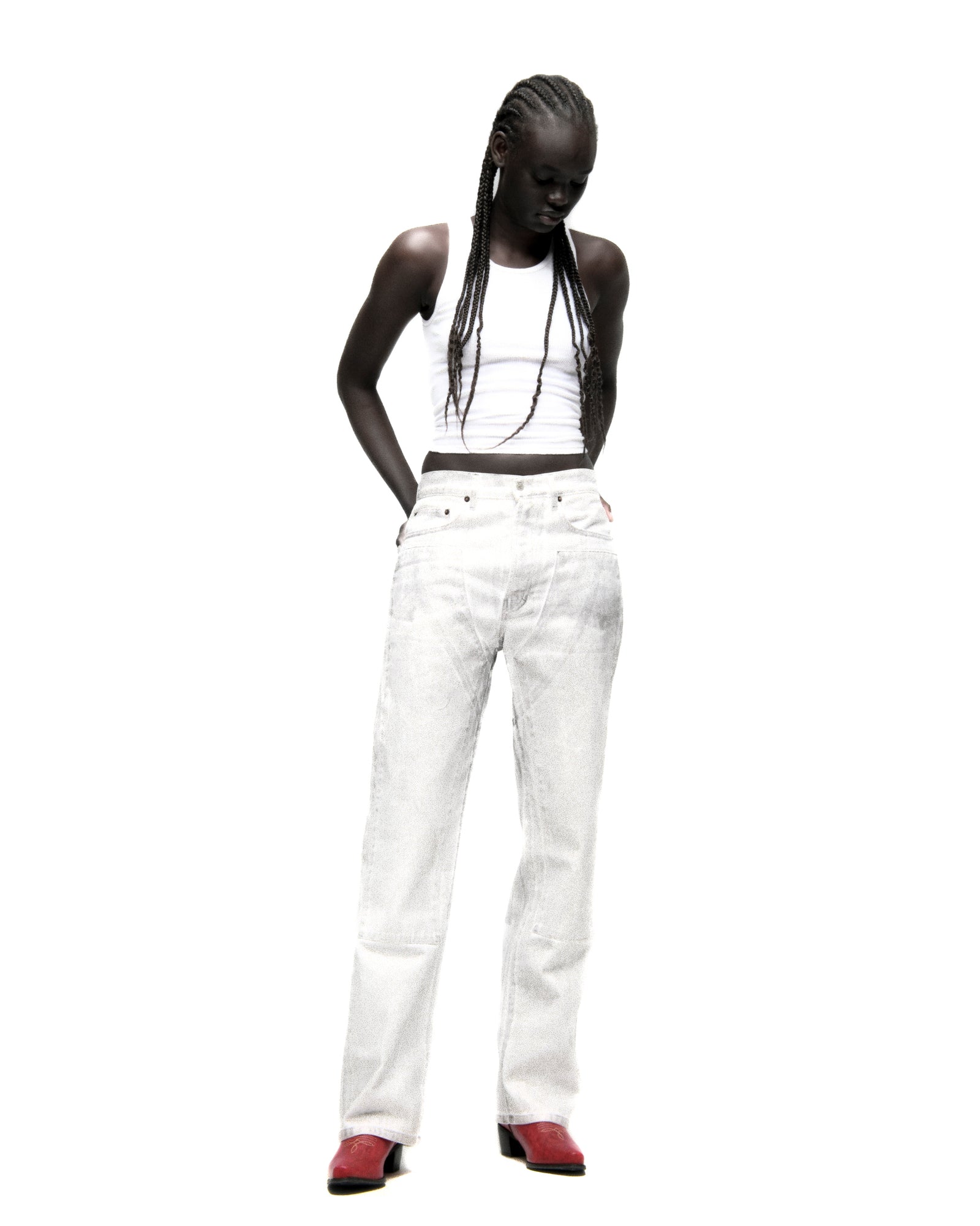 Model wearing wide-leg PLATINUM DENIM PANT with a spray effect, five-pocket styling, and custom hardware.