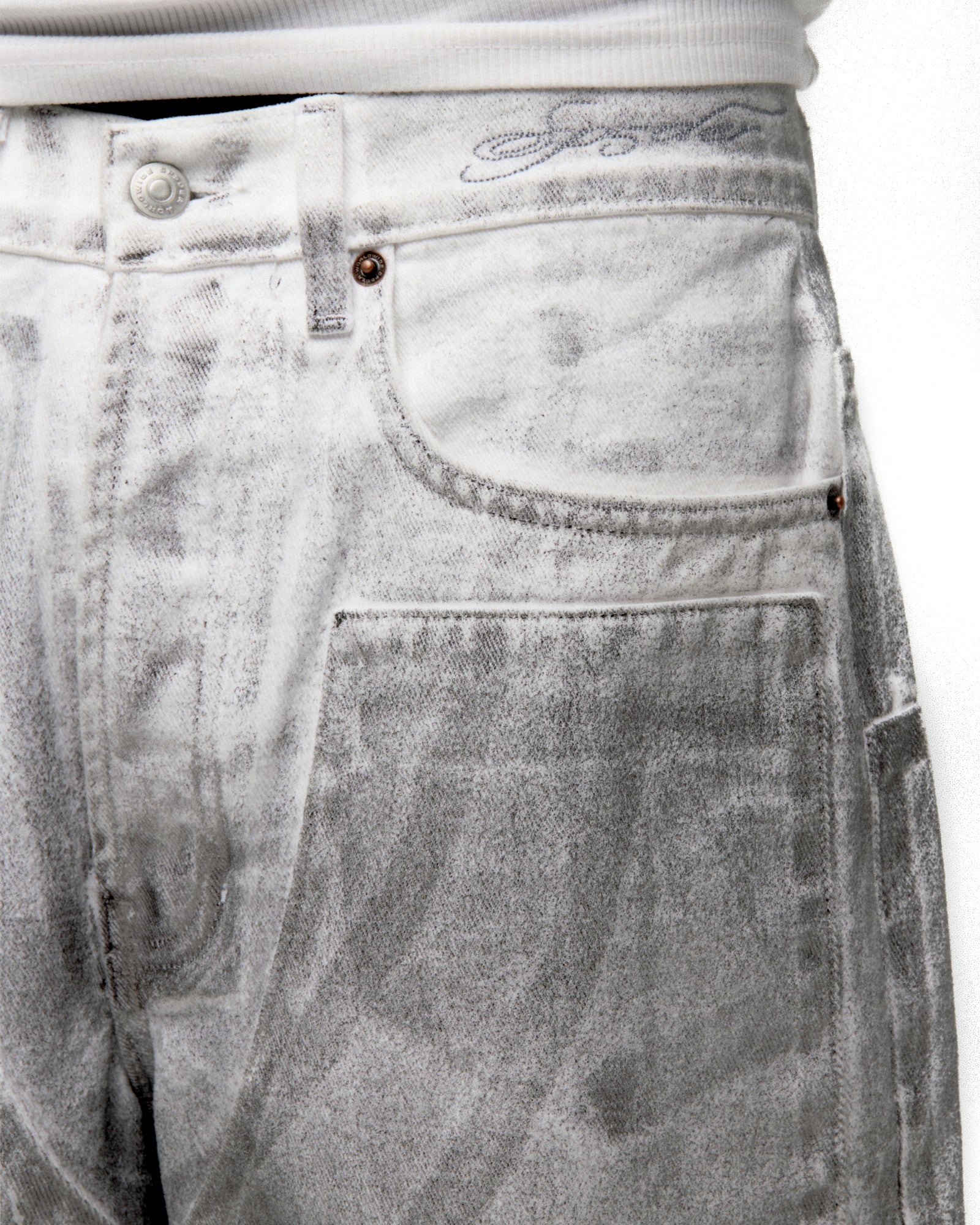 Platinum denim pant with spray-effect wash, custom hardware, and front panels.
