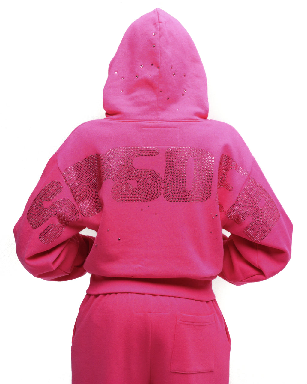 Back of a pink 100% cotton fleece hoodie with a rhinestone design, hood, and ribbed cuffs.
