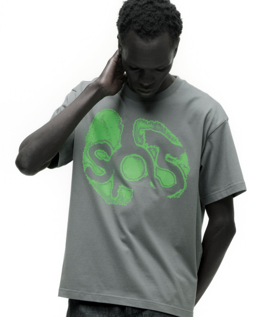 Man in a standard fit, grey cotton FINGERPRINT TEE with a bright green "SOS" graphic print.