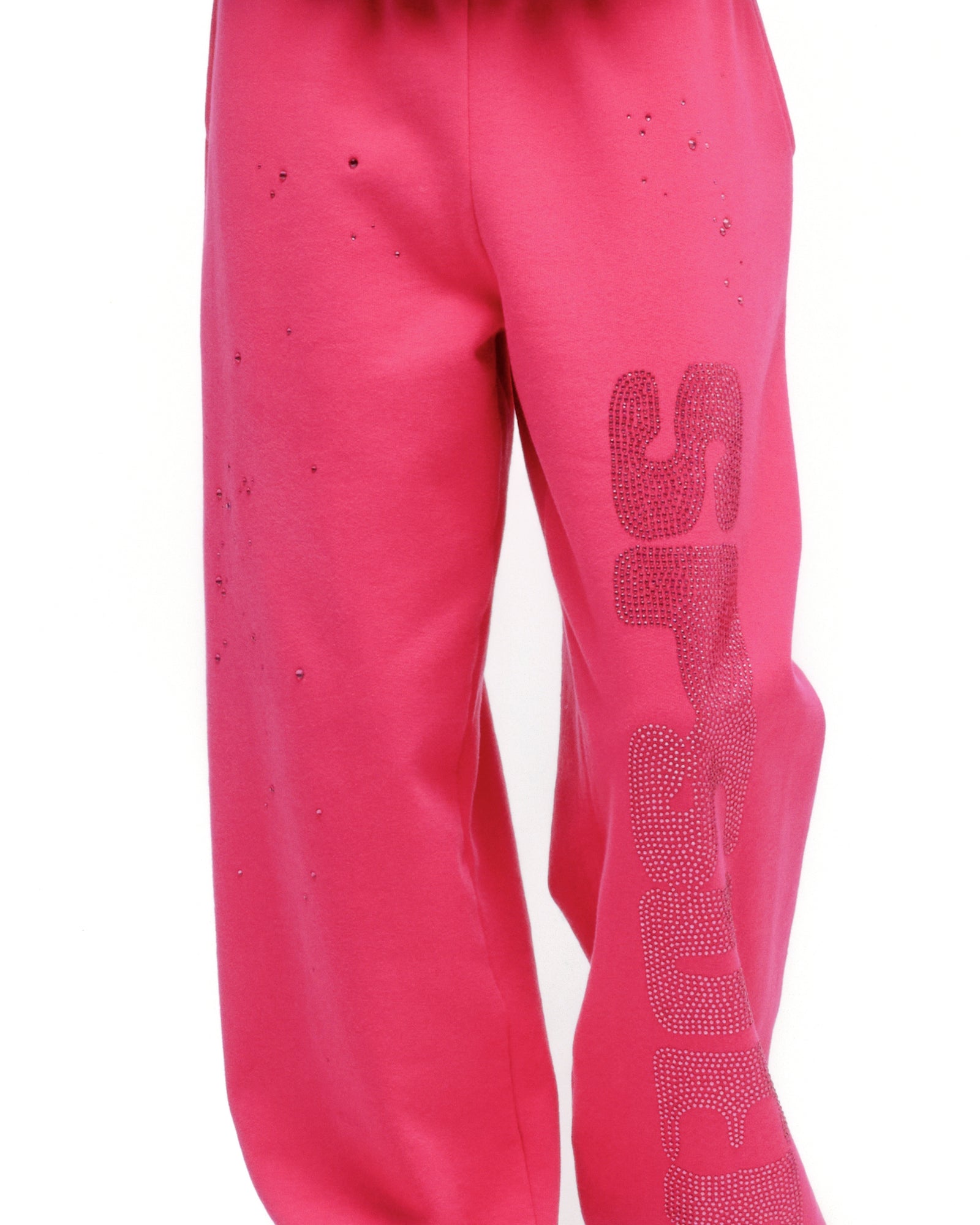 Pink cotton fleece sweatpants with rhinestone embellishment on the leg, elasticized waistband and cuffs.