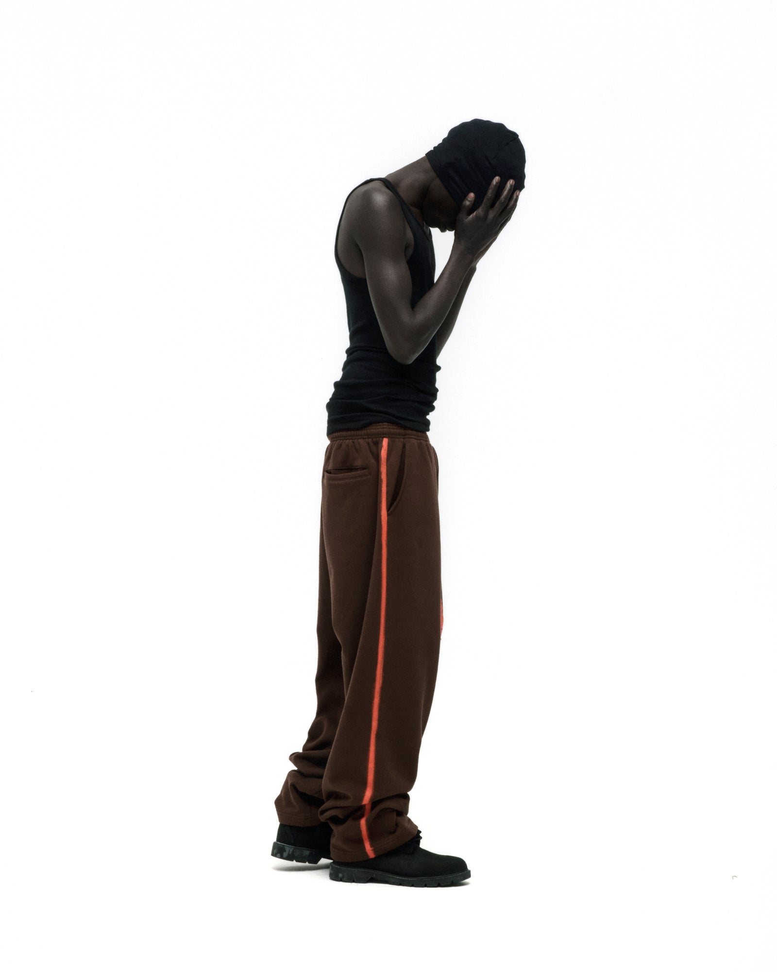 Brown SCREAMING EAGLE SWEATPANT with orange sprayed-effect side stripe, wide-leg, and elasticized waistband.