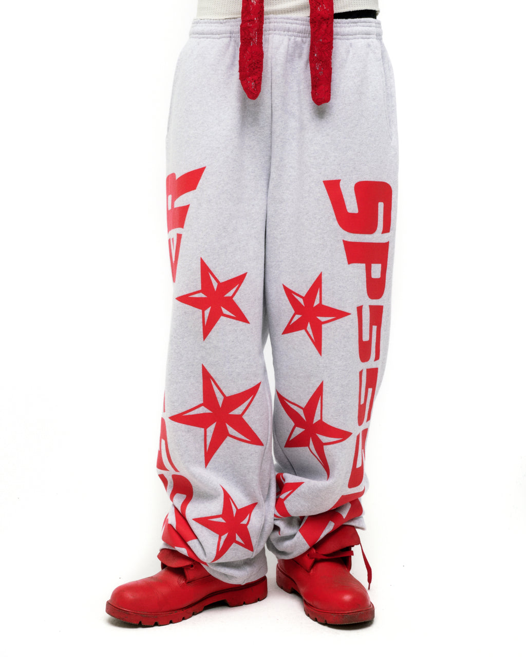 Grey MX555 sweatpants with red foil SP5DER logo, stars, drawstring, and wide-leg fit.