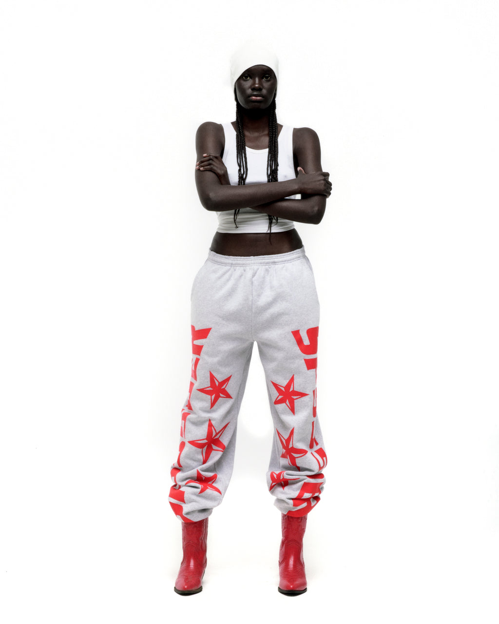 Grey MX555 sweatpants with red foil SP5DER and star print, elastic waistband, wide-leg.