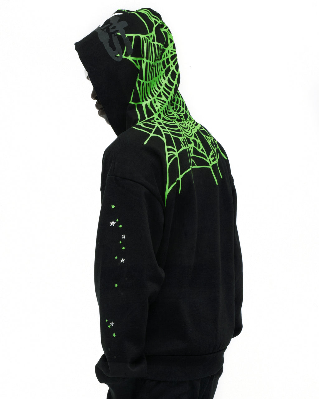 Black heavy web hoodie with neon green spider web print on hood and shoulders, scattered stars on sleeve.