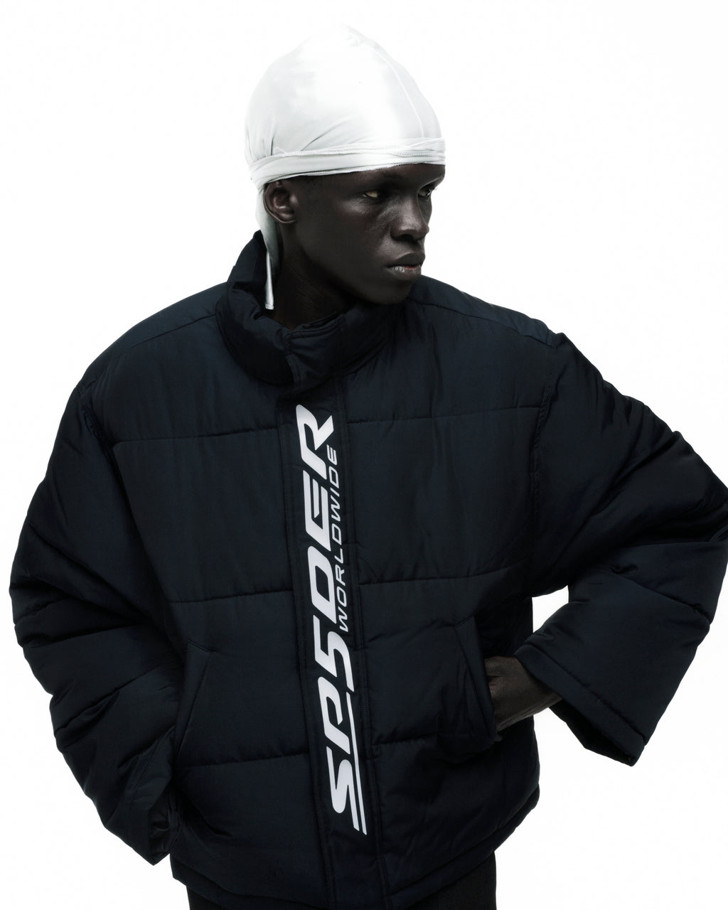 Black TRACKHAWK PUFFER JACKET with white SP5DER WORLDWIDE reflective text along front zip.