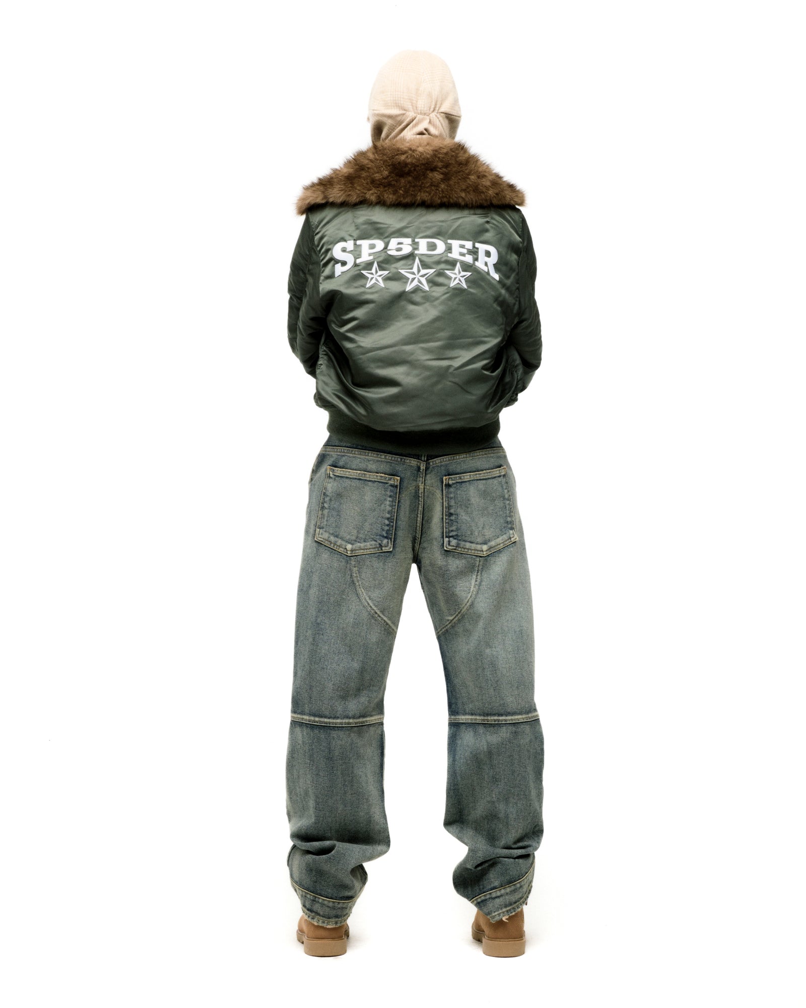 Green nylon bomber jacket with faux fur collar and white SP5DER star graphic on back.