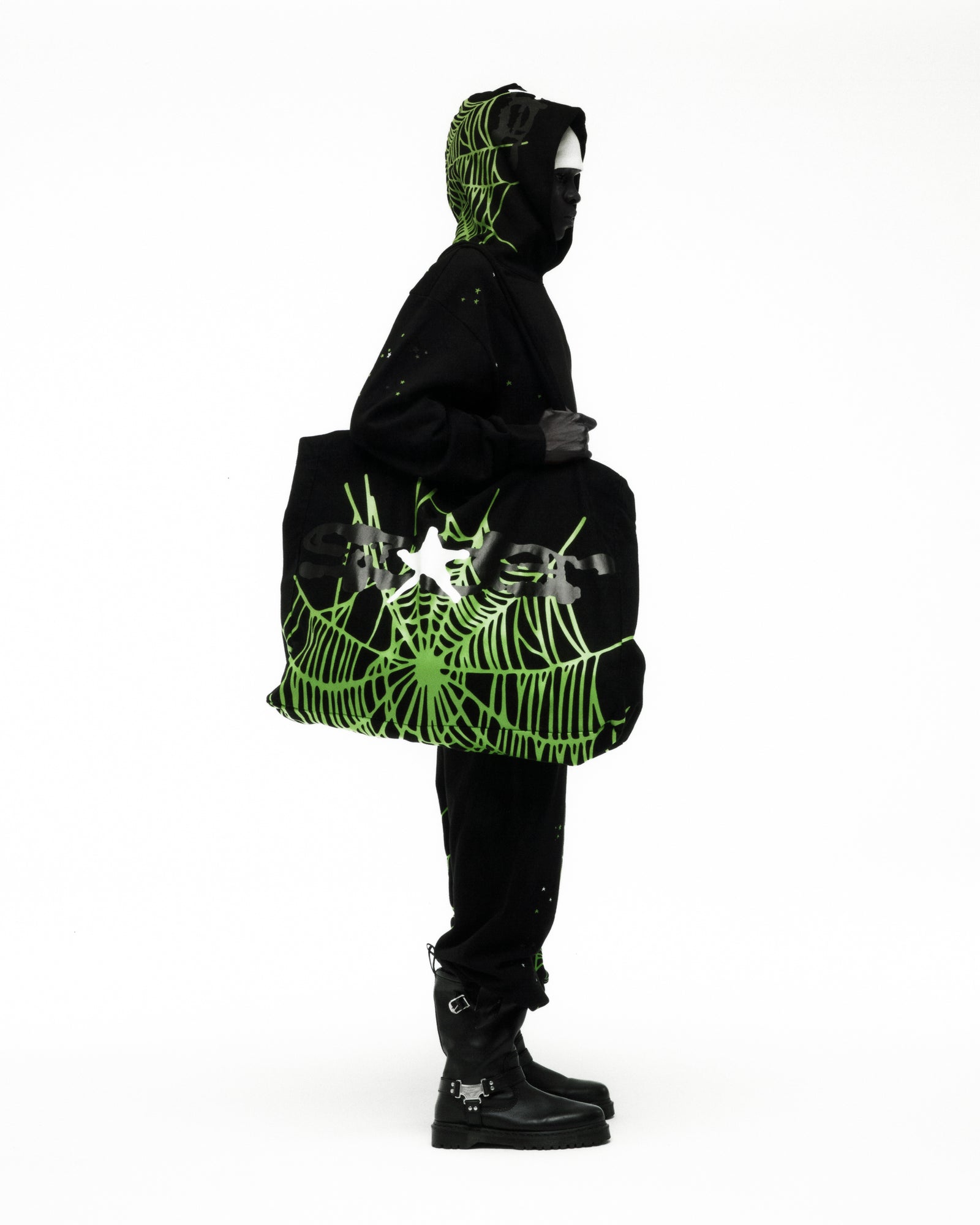 Black 8oz brushed twill HEAVY WEB TOTE with bright green spider web graphic print, carried by a person.