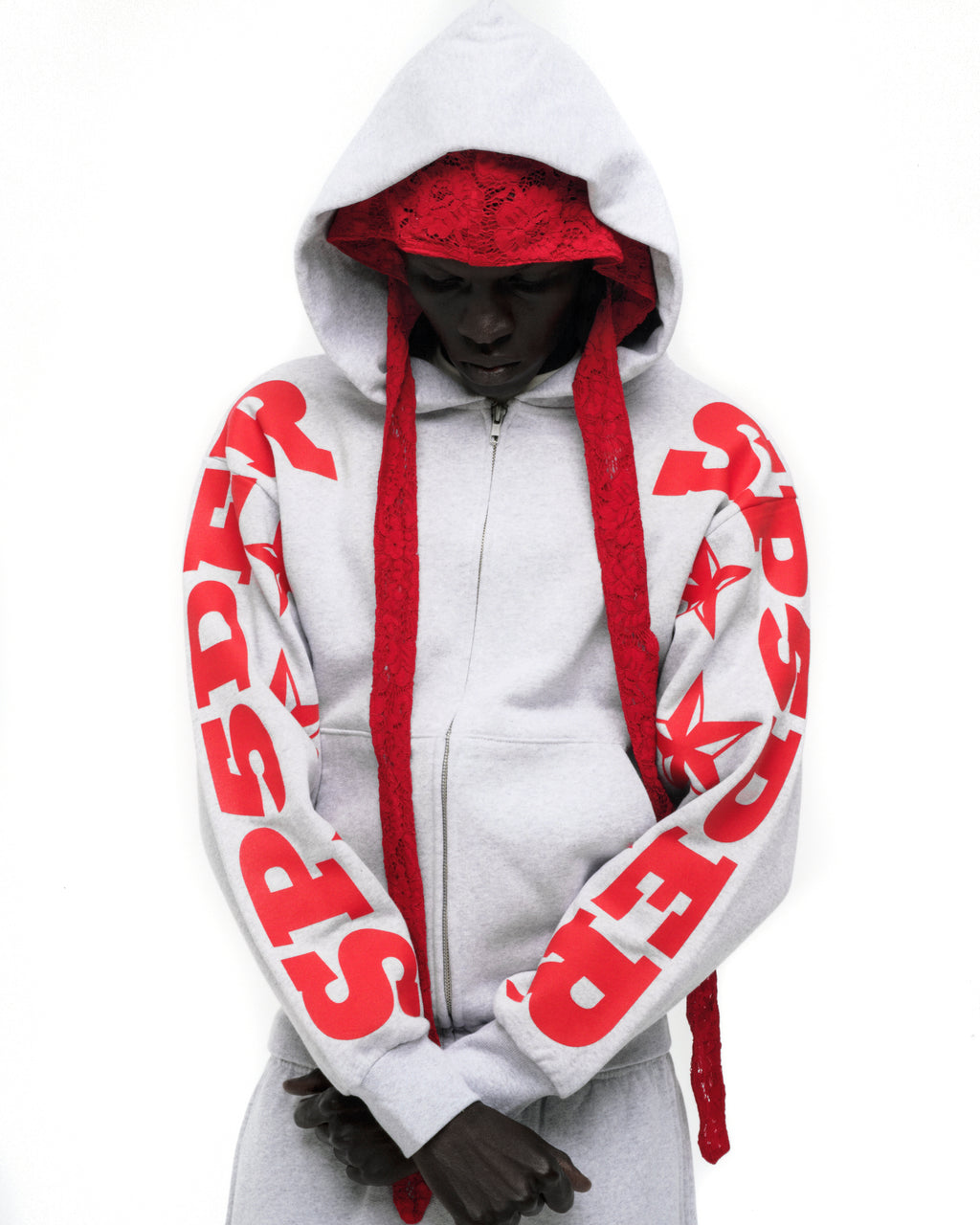 Light grey MX555 zip hoodie with red SP5DER and star print on sleeves, kangaroo pocket, and ribbed cuffs.
