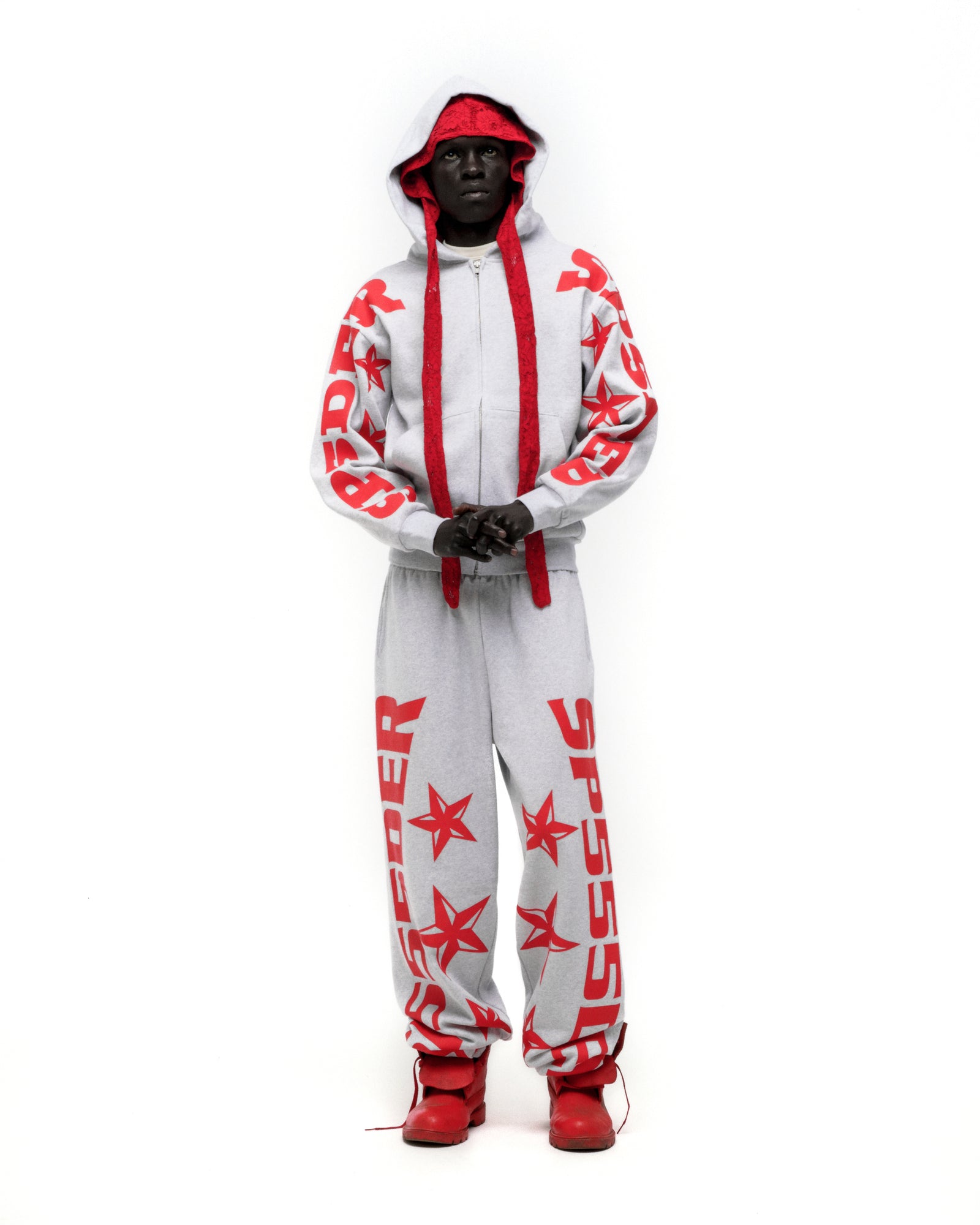 Light grey MX555 sweatpant with red SP5DER and star print, wide-leg, and drawstring.