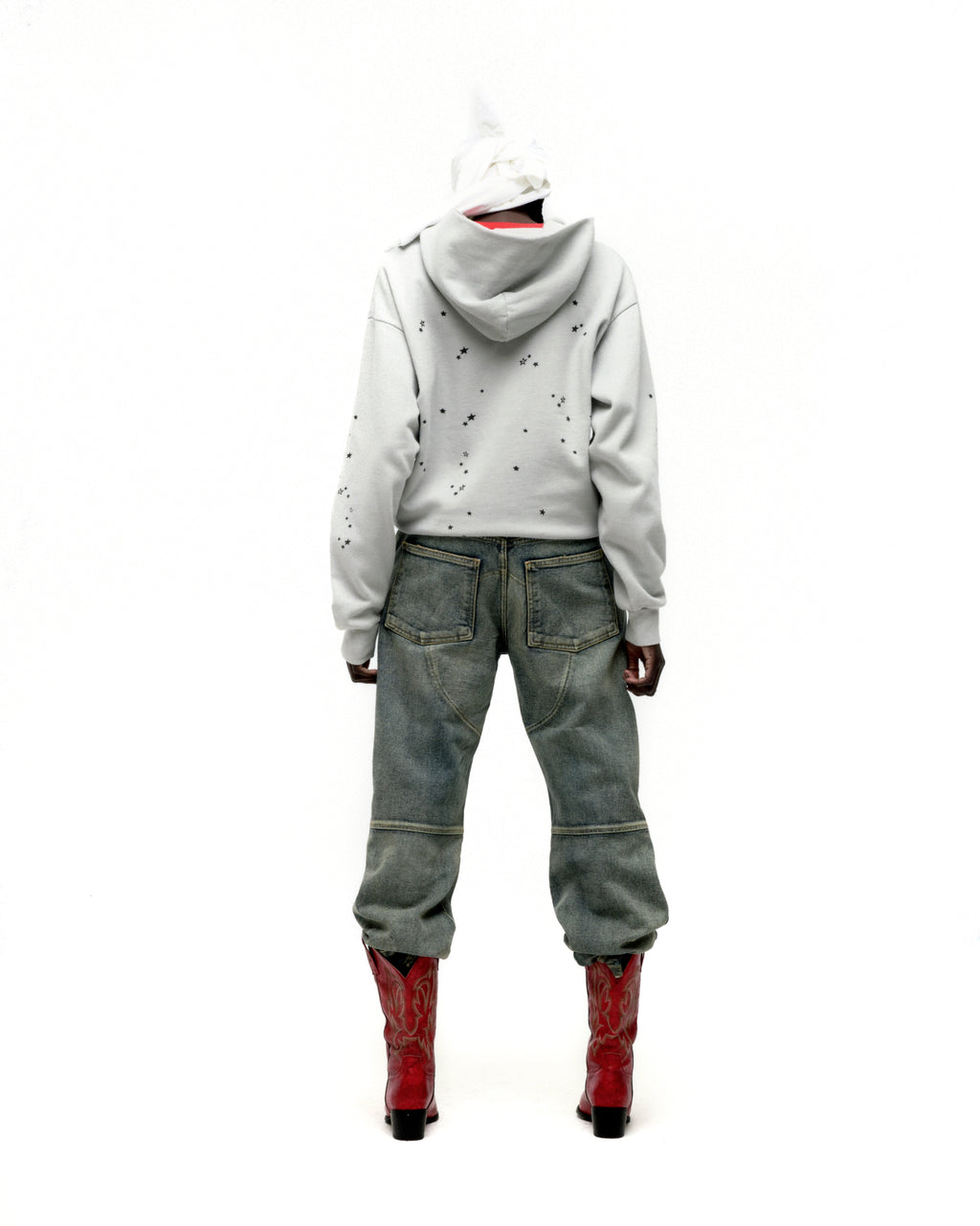 Light grey 100% cotton fleece Star Girl Hoodie with scattered star print, worn with jeans and red boots.