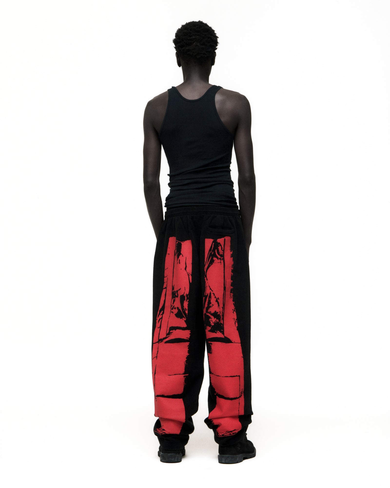 Black cotton fleece JP5 Moto Sweatpants with red painted design, wide-leg, and elasticized waistband.