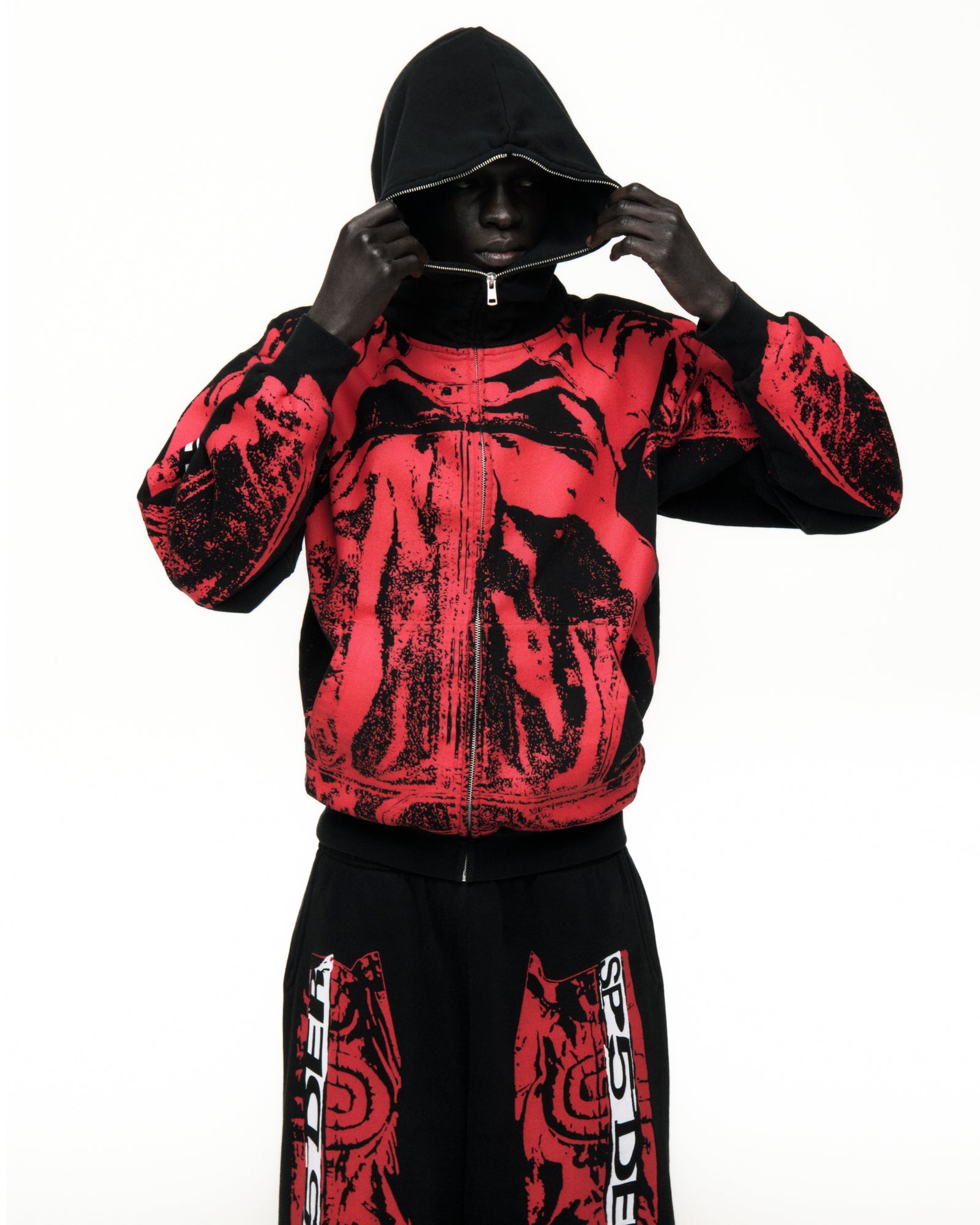 Black and red JP5 Moto Hoodie with painted design, full zipper, and ribbed cuffs.