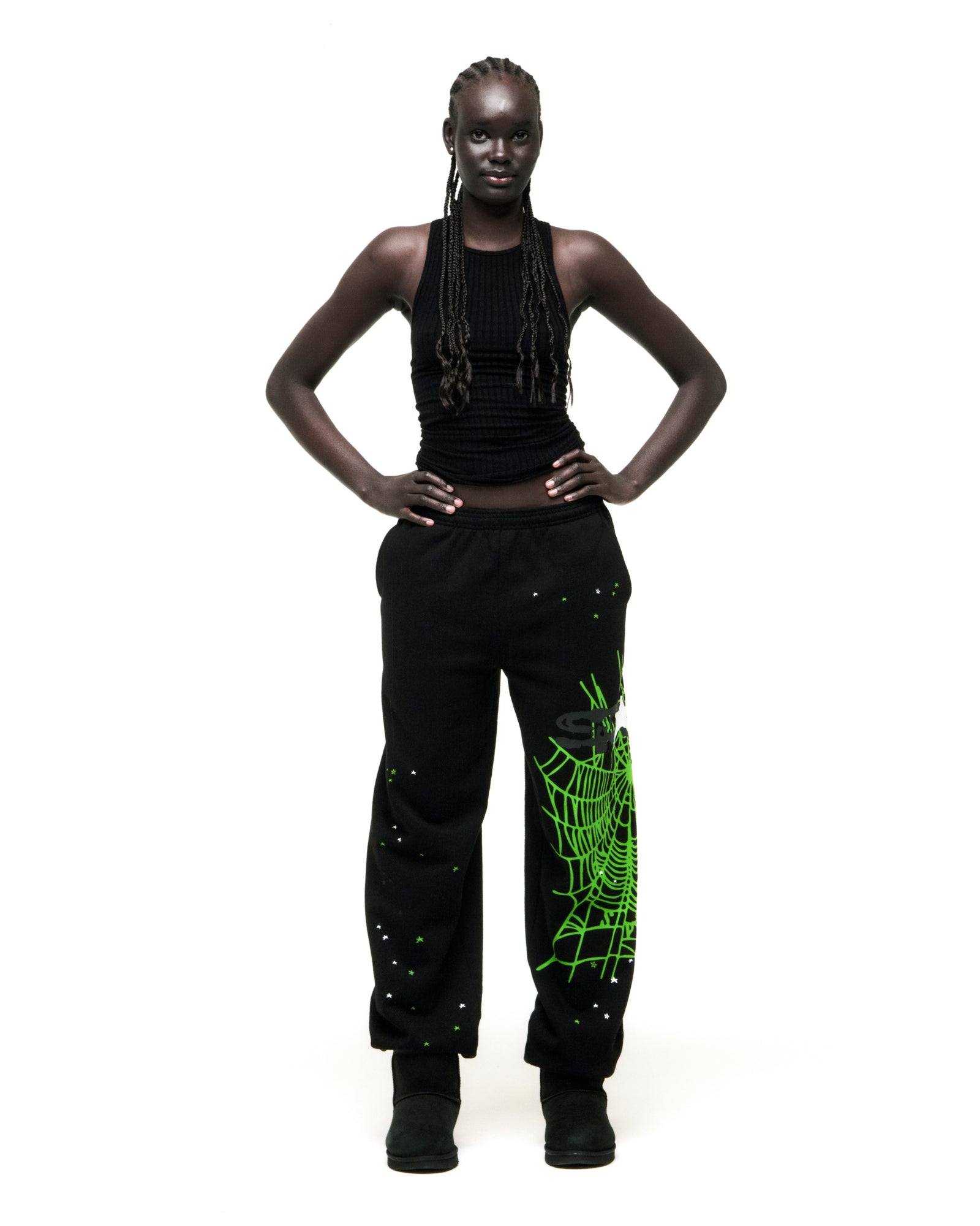 Black HEAVY WEB SWEATPANT with green SP5DER web graphic and scattered stars, worn by a model.
