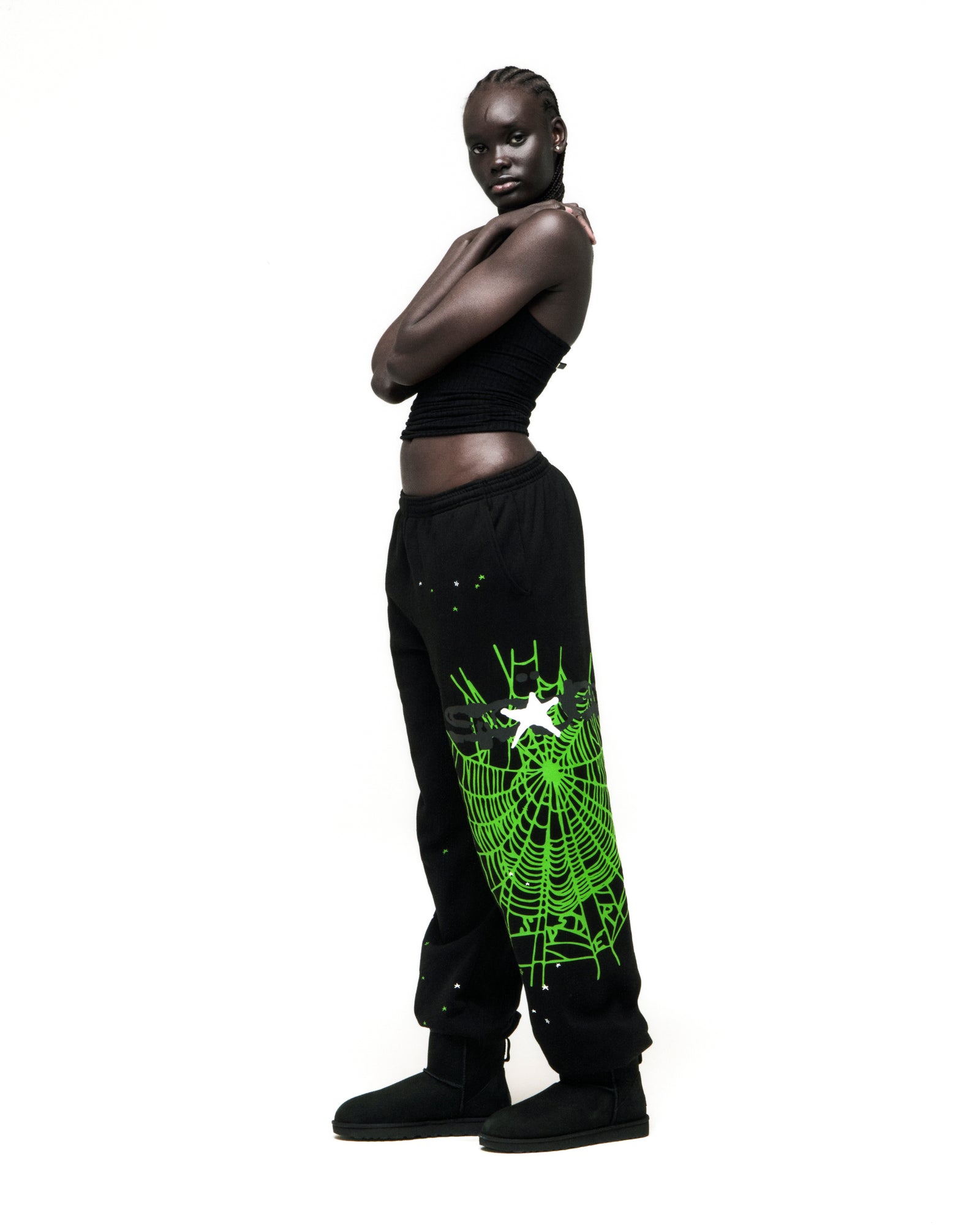 Black HEAVY WEB SWEATPANT with neon green SP5DER web graphic, scattered stars, and elasticized cuffs.