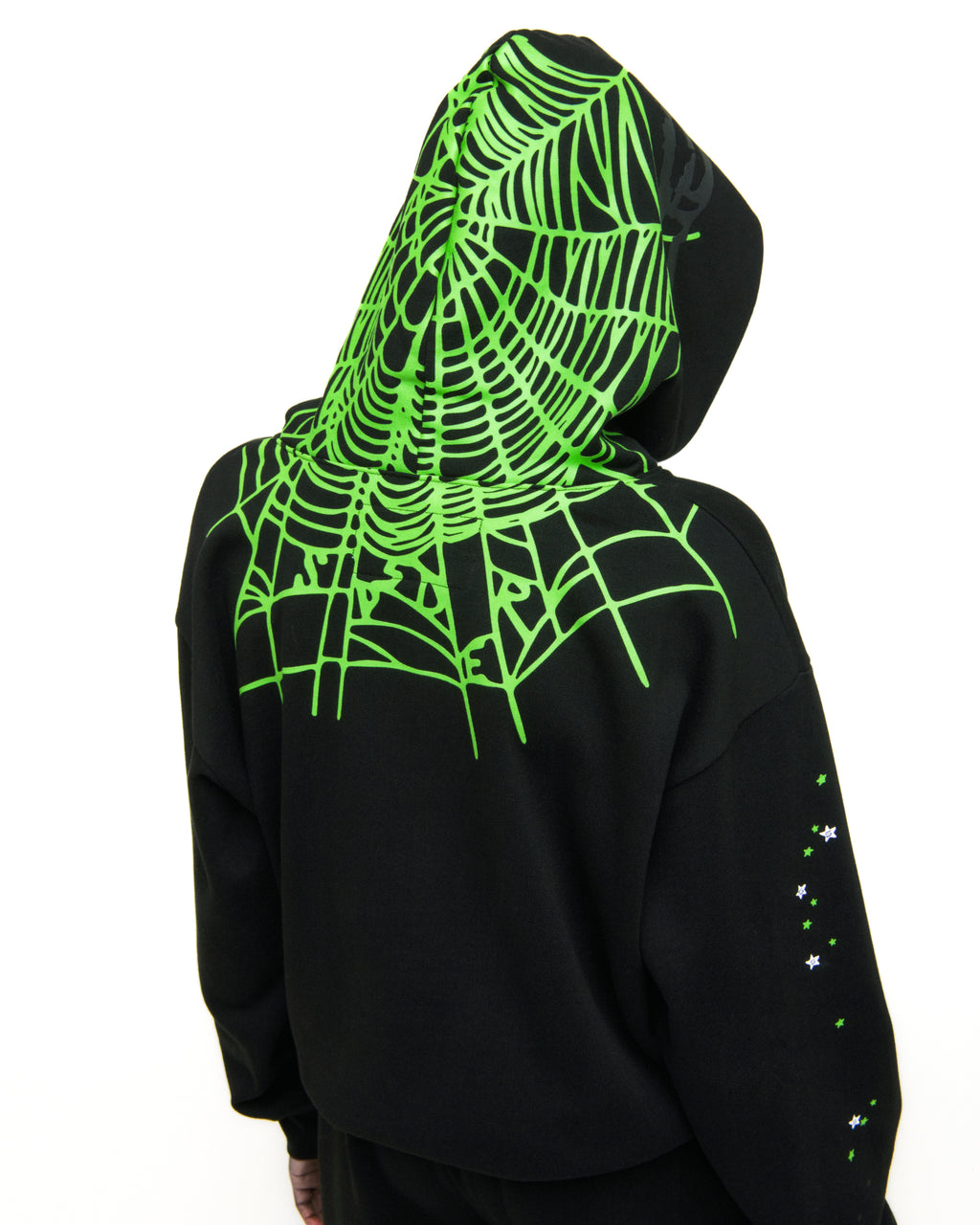 Black heavy web hoodie with neon green spiderweb print on hood and back, scattered stars on sleeve.