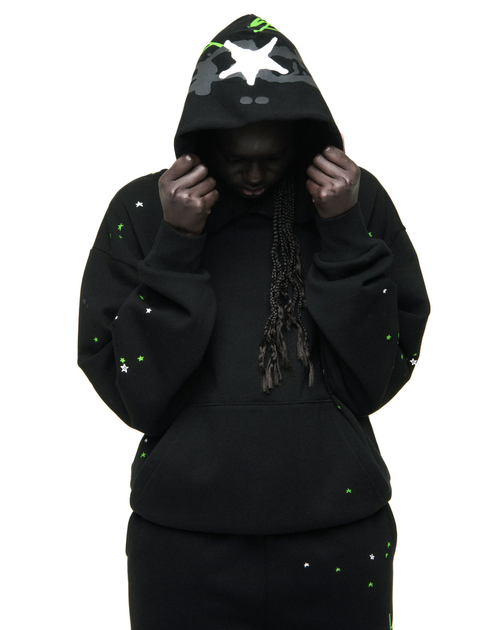 Black heavy web hoodie with scattered green and white stars, puff print, and kangaroo pocket.