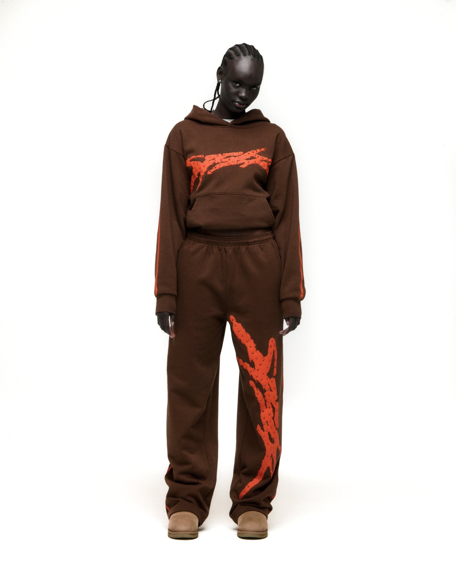 Brown cotton fleece hoodie and sweatpants with orange flaming graphics and stripe details.