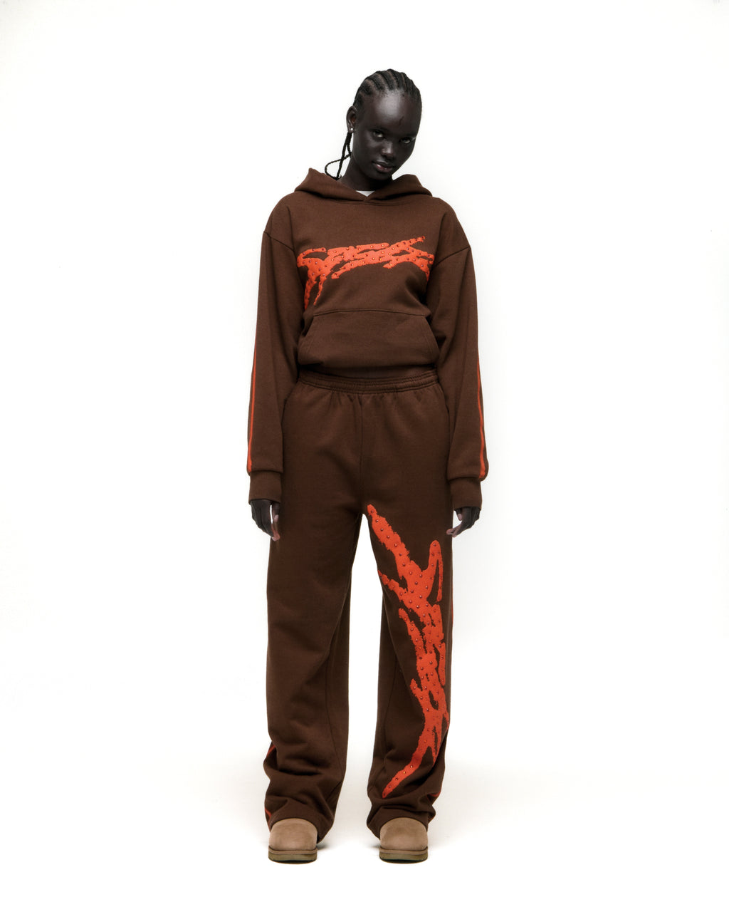 Brown cotton fleece hoodie and sweatpants with orange flaming graphics and stripe details.