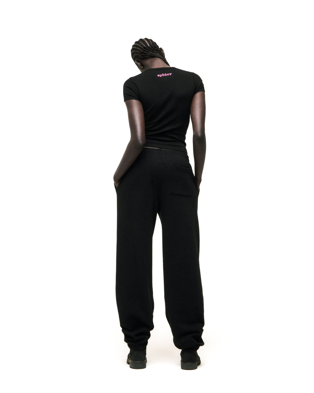 Black cotton/spandex cropped tee with pink 'SP5DER' logo on back neck, worn by a model.