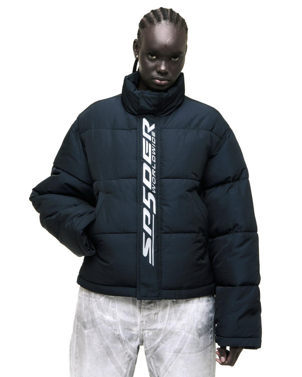 Black poly-fill puffer jacket with reflective "SP5DER WORLDWIDE" text along the front zip and snap placket.