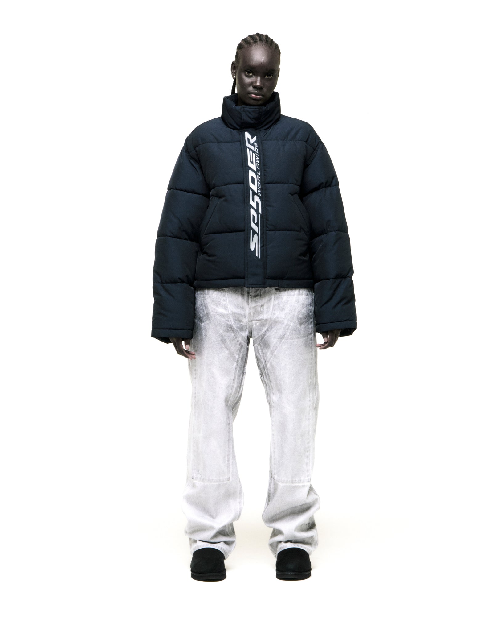 TRACKHAWK Puffer Jacket: Dark blue poly-fill jacket with reflective "SP5DER WORLDWIDE" text graphic along front zip.