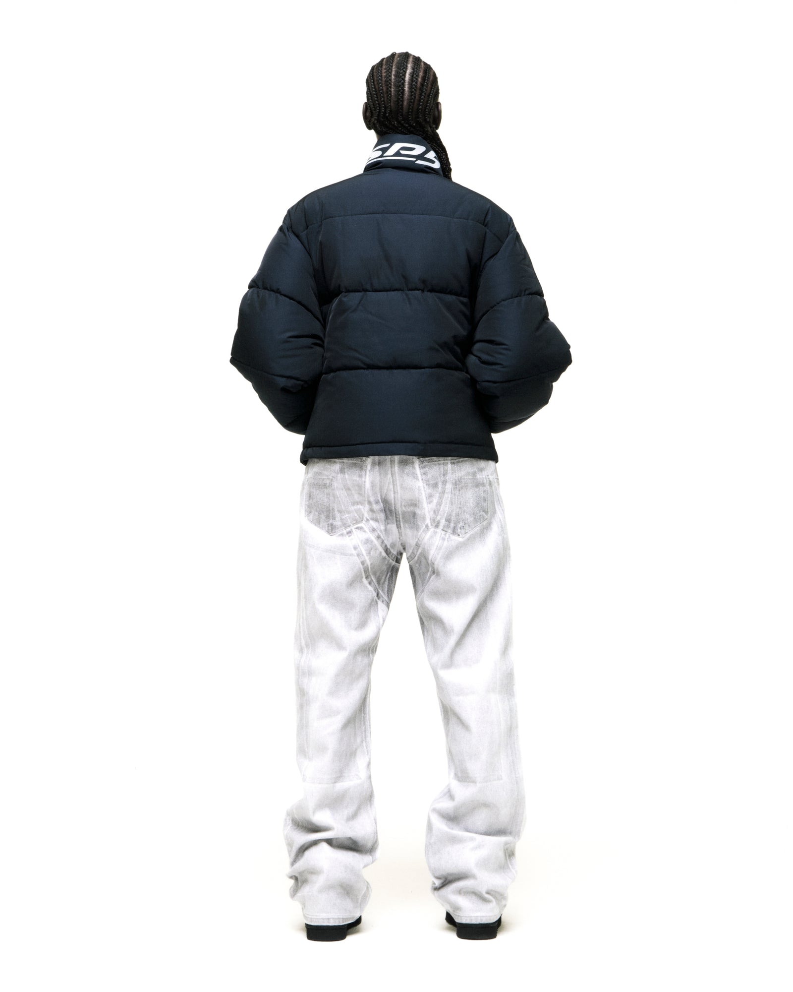 TRACKHAWK black poly-fill puffer jacket with reflective text graphic at back neck collar.