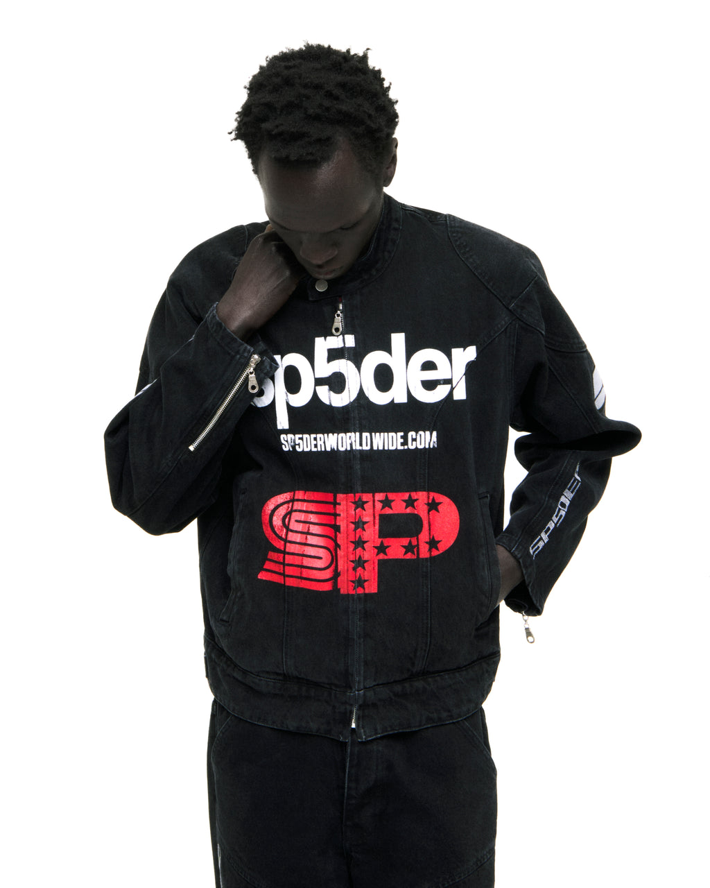 Black faded wash denim jacket with white "Sp5der" chest print, red "SP" star print, and zip closure.
