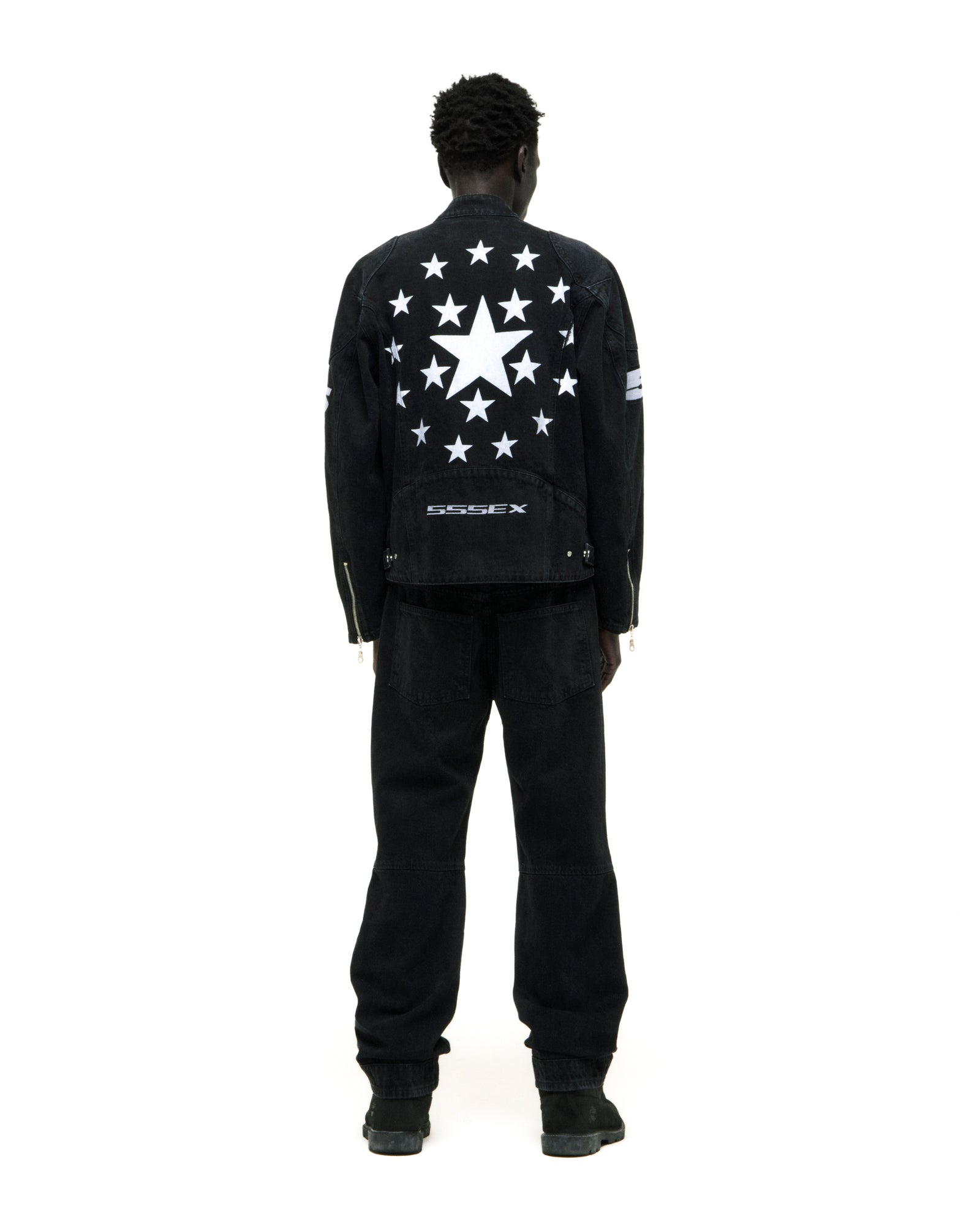 Black faded wash denim jacket with white star print on back and "SSSEX" embroidery.