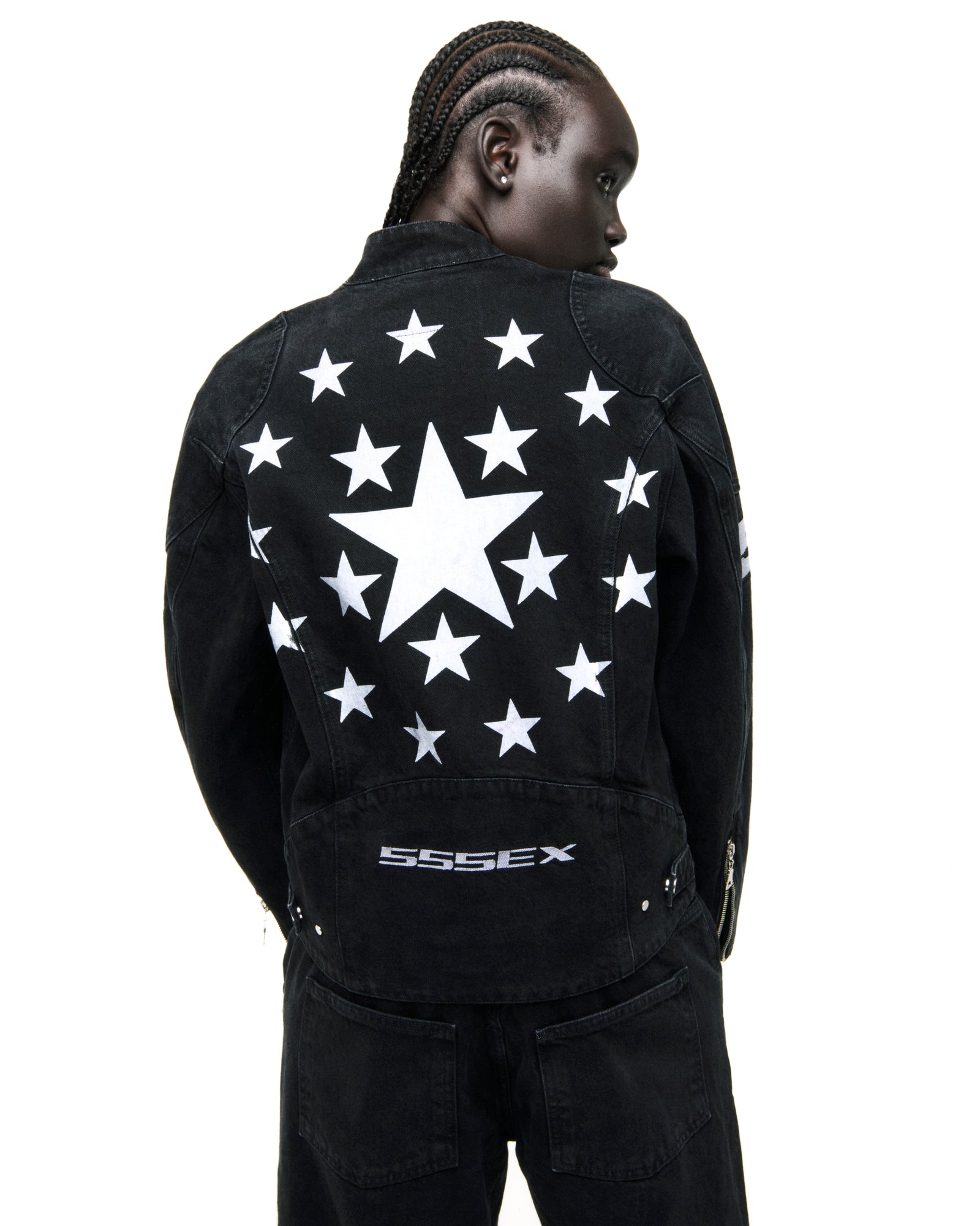 Faded black denim jacket with large white star on back, surrounded by smaller stars, and "SSSEX" embroidery.